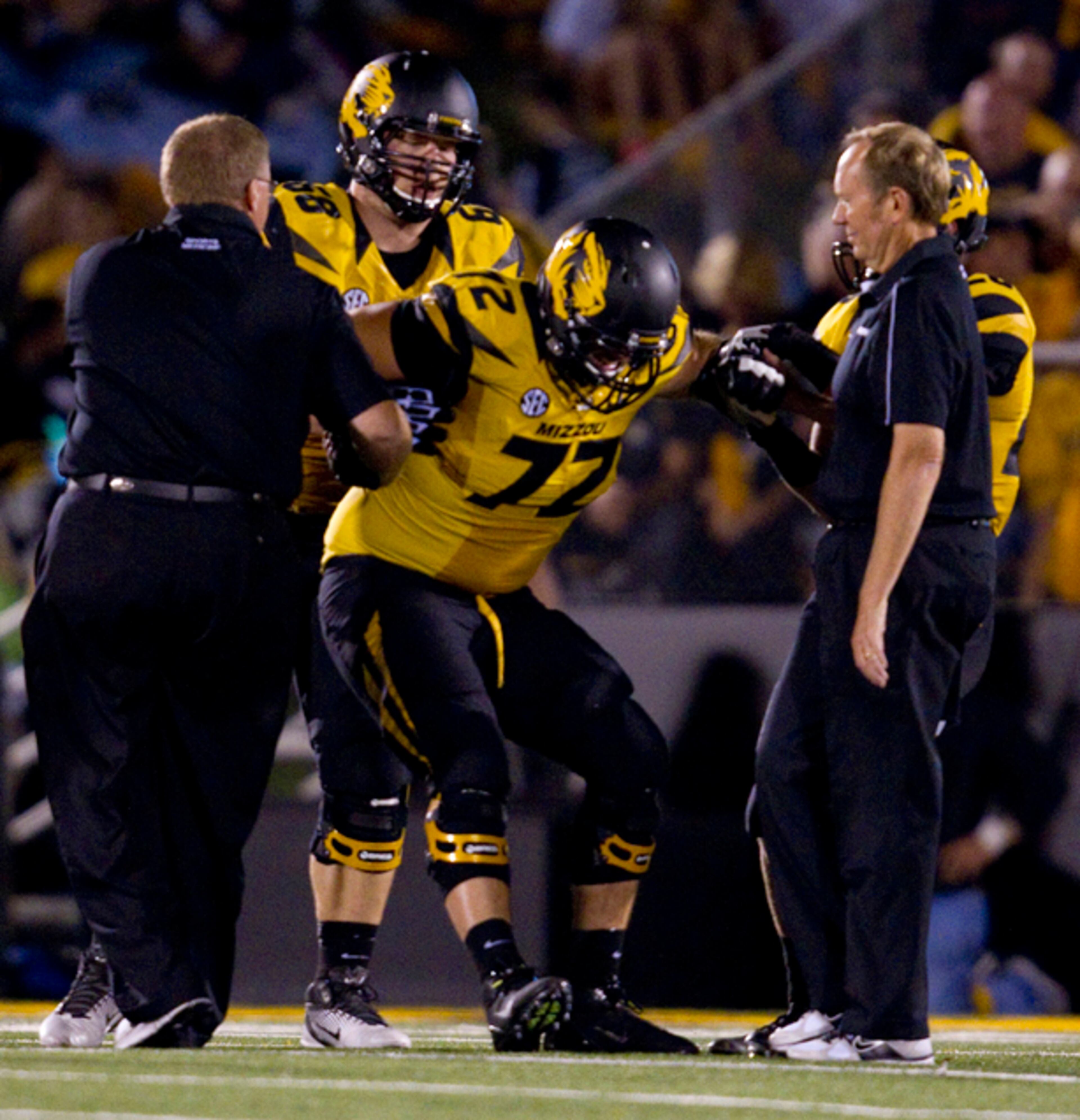 Missouri offensive linesman Elvis Fisher (72) is helped up off of the turf after he was injured in the second quarter.
