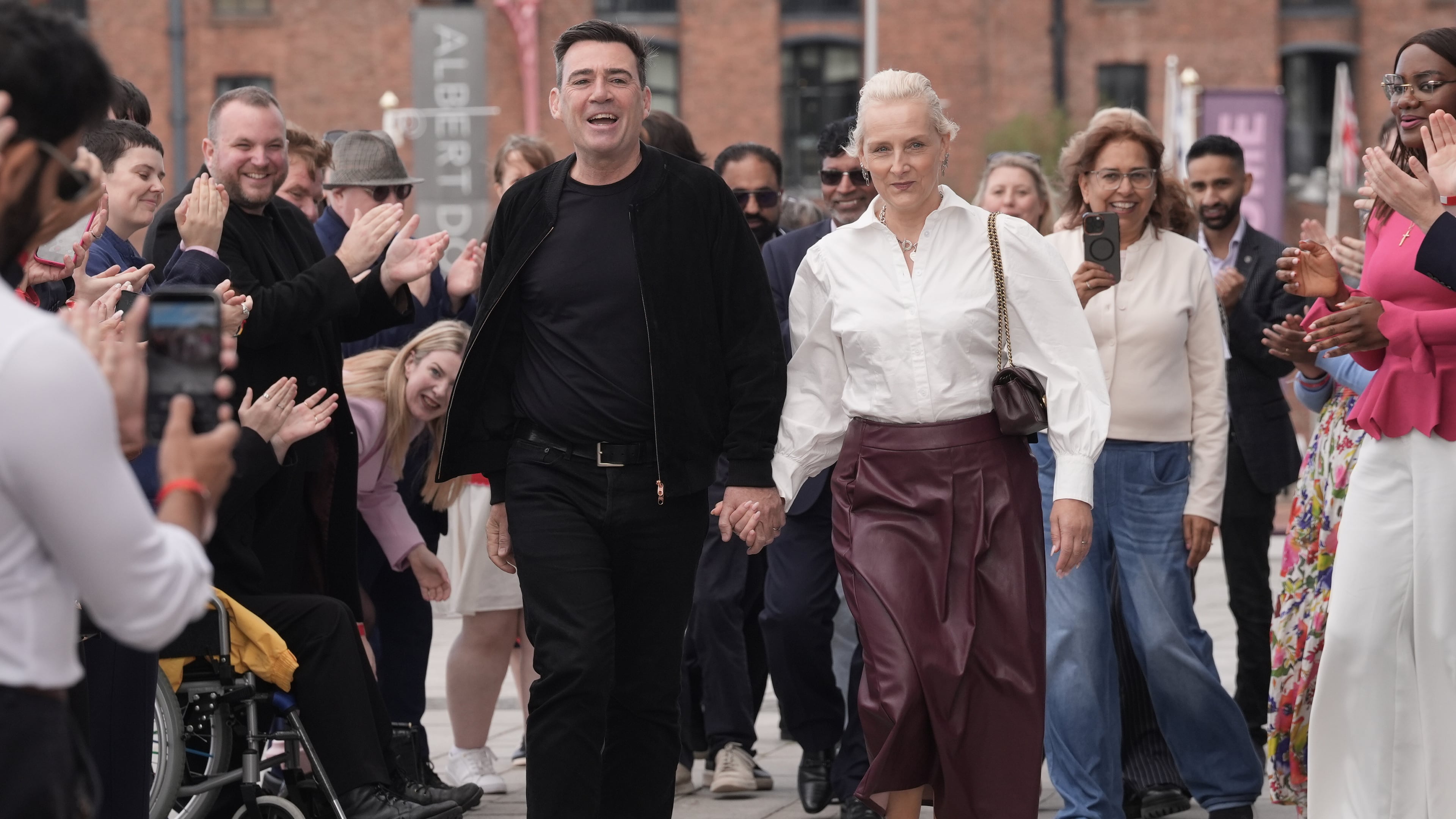 Britain's Prime Minister Andy Burnham and his wife Marie-France Van Heel arrive for the Labour Party Conference at the ACC Liverpool, in Liverpool, England,, Saturday, Sept. 26, 2026. (Stefan Rousseau/PA via AP)