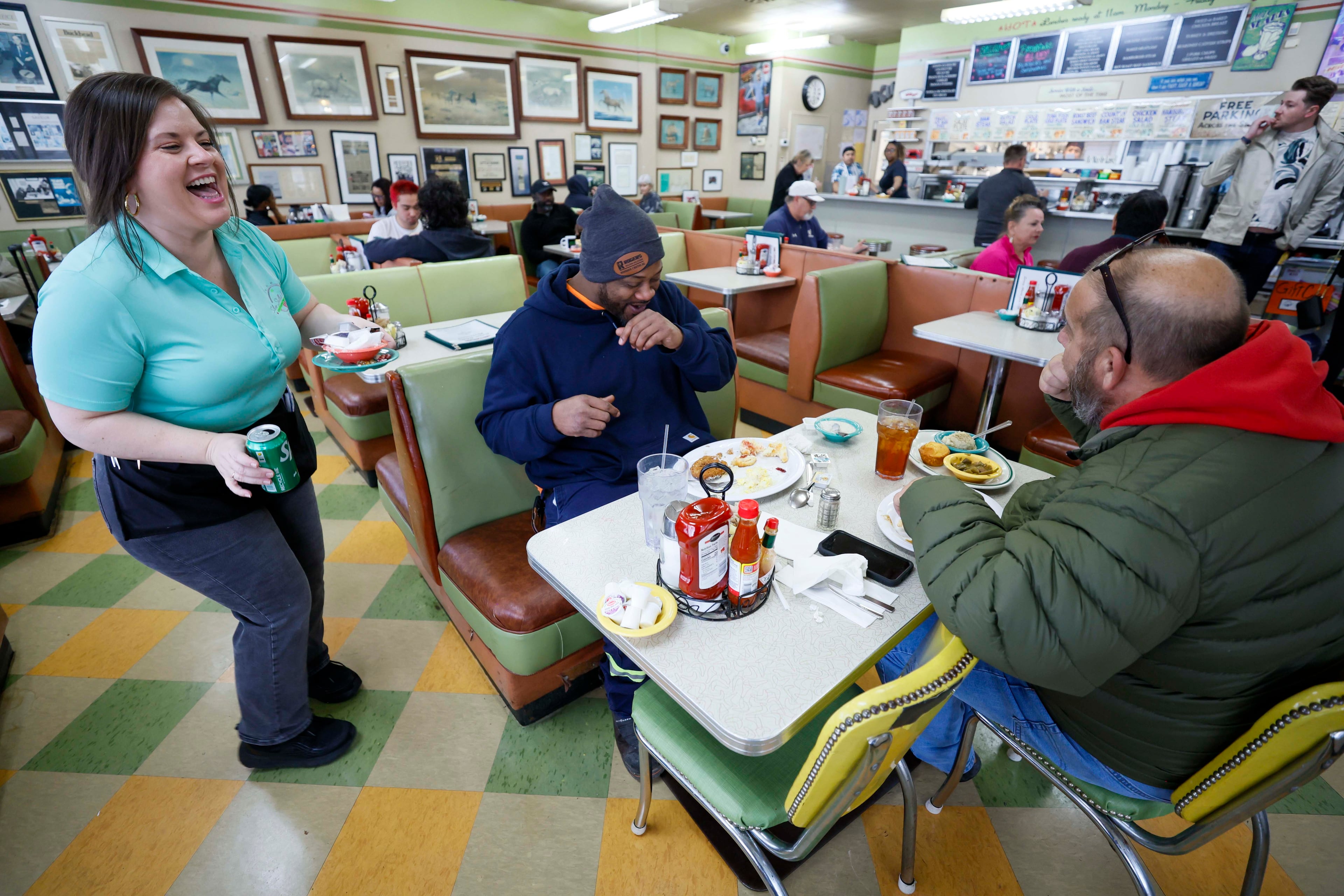 Nikki Lancaster, an 11-year veteran working at the Silver Skillet restaurant in Midtown, laughs while interacting with regular customers Roderick Jefferson and Jim Gossett on Thursday, Jan. 22, 2026. The well-known Midtown eatery has appeared in numerous movies and TV shows. (Miguel Martinez/AJC)