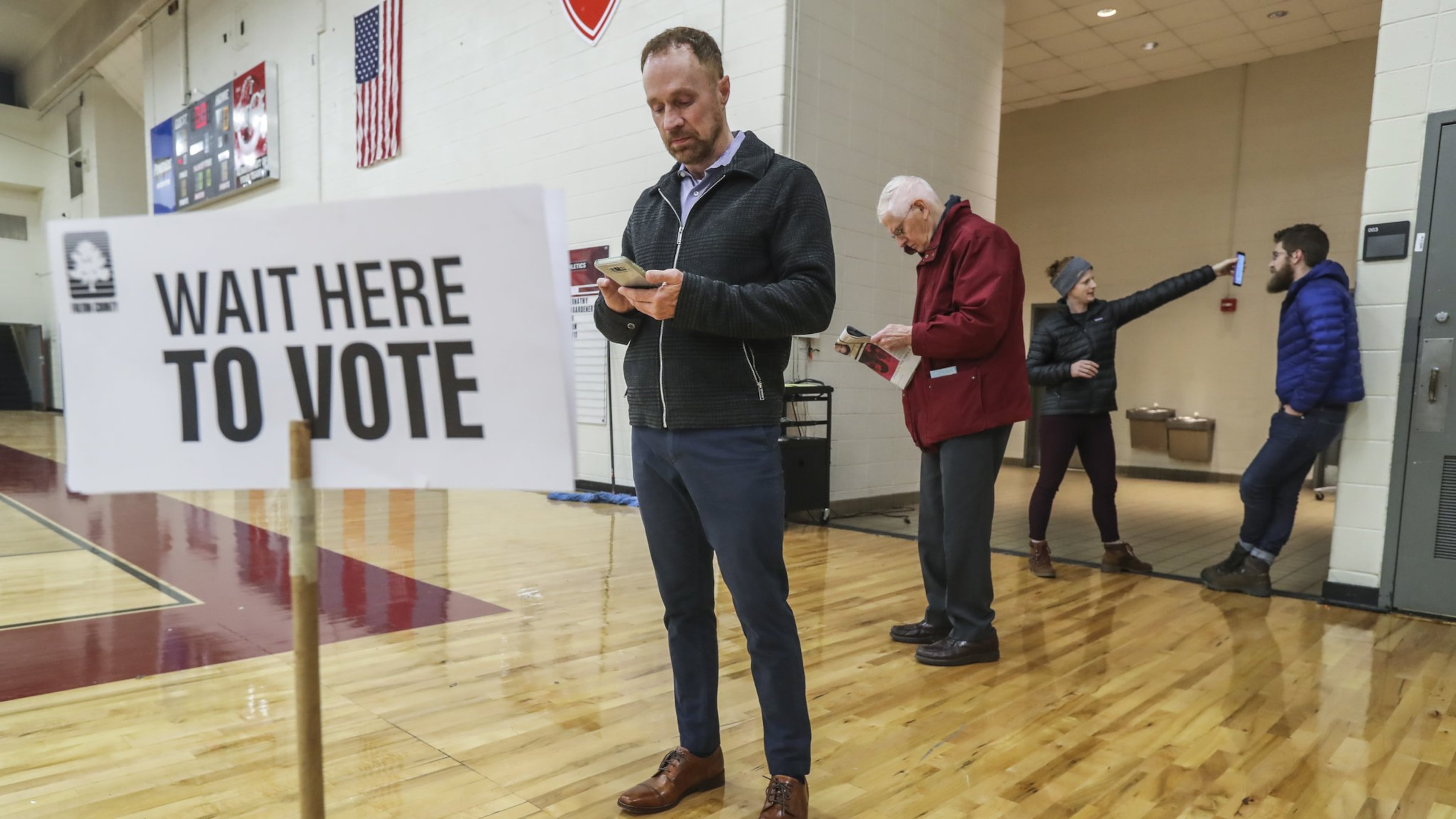 Grant Jones was first in line at Henry W. Grady High School in Atlanta as Georgia saw a lighter turnout of voters for a runoff election in December. JOHN SPINK/JSPINK@AJC.COM