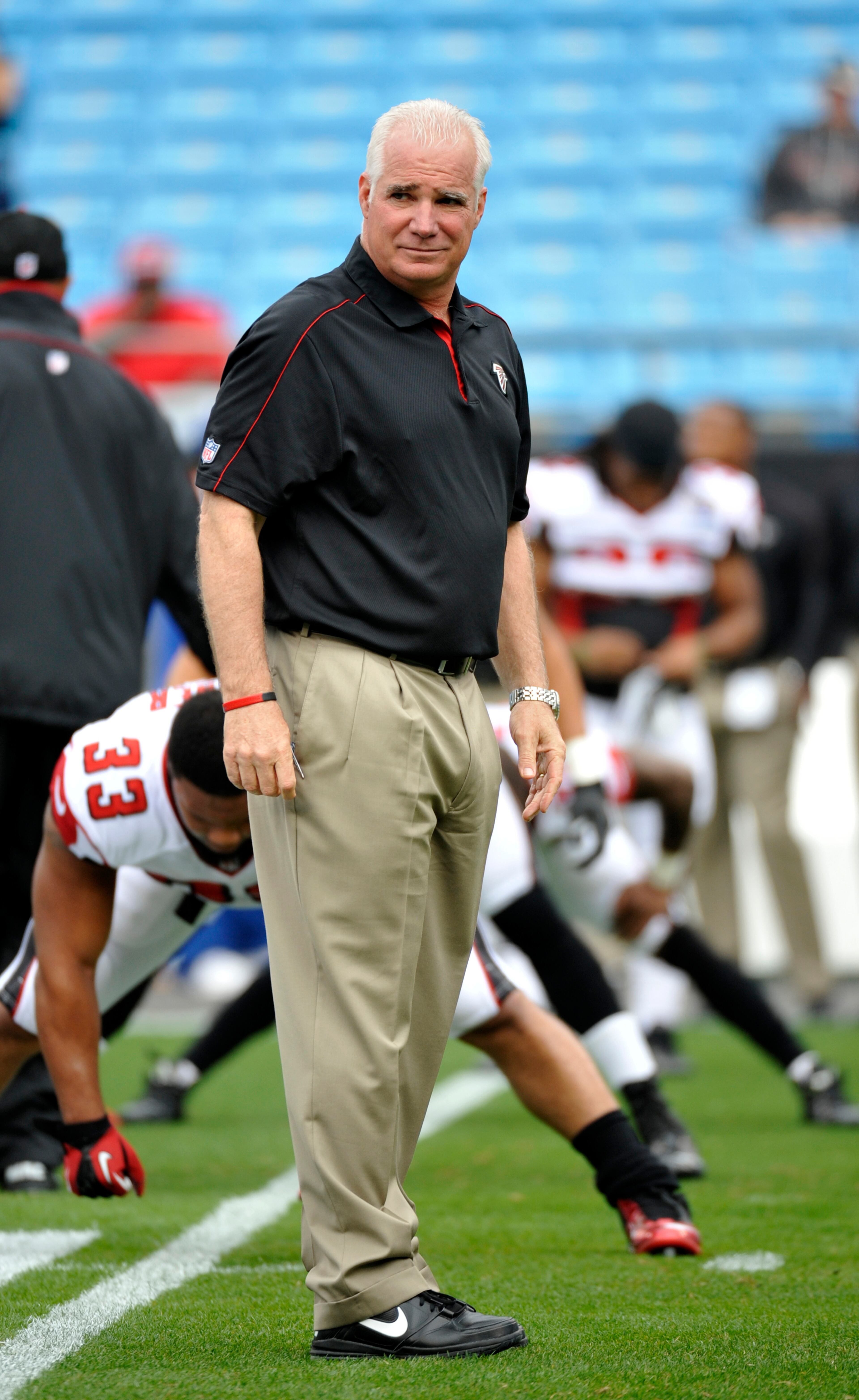 Atlanta Falcons head coach Mike Smith looks on as teams warm up before an NFL football game against the Carolina Panthers in Charlotte, N.C., Sunday, Dec. 9, 2012. (AP Photo/Rainier Ehrhardt)