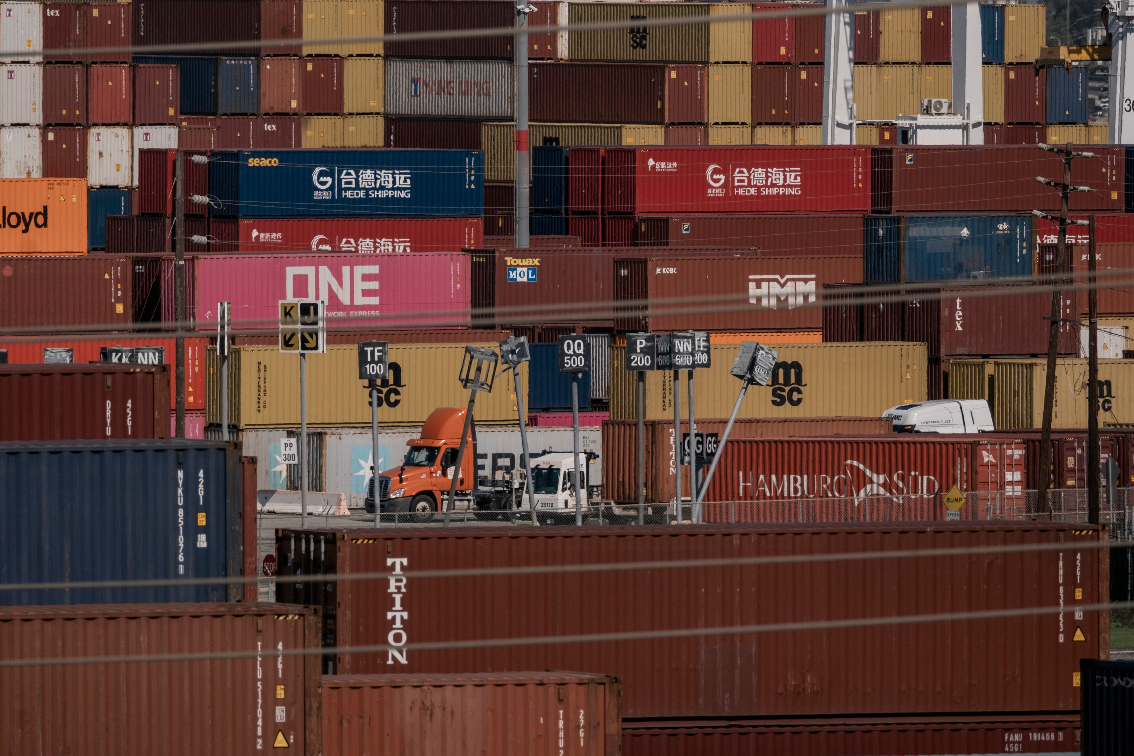 Trucks hauling shipping containers at the Port of Los Angeles in February 2025. An easing in President Donald Trump’s tariffs on Chinese goods gave businesses some breathing room, but long-term planning is still on pause. (Mark Abramson/The New York Times)