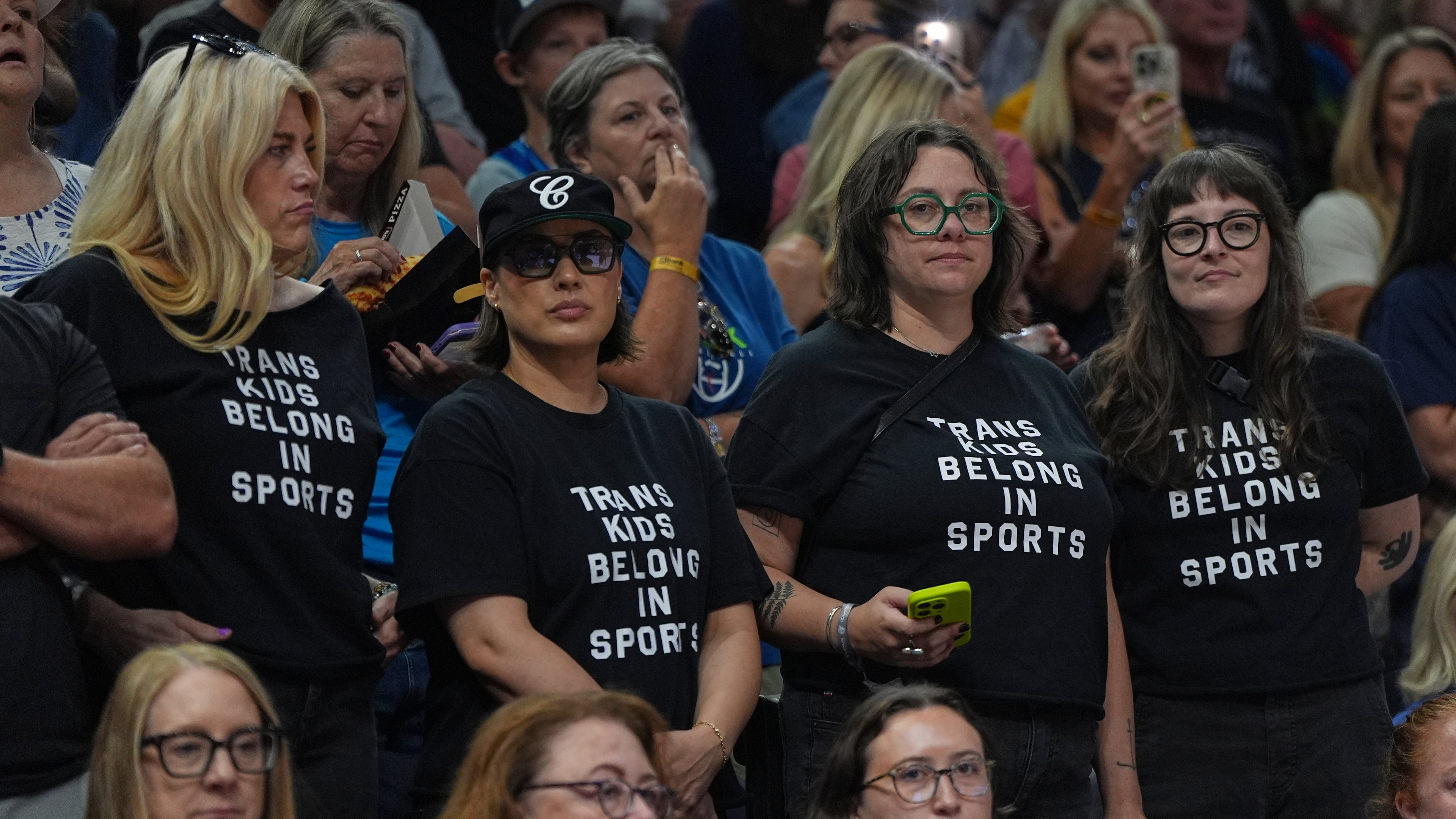 Fans wear shirts saying "Trans Kids Belong In Sports" during a WNBA basketball game between the Minnesota Lynx and the Indiana Fever Sunday, Aug. 2, 2026, in Minneapolis. (AP Photo/Abbie Parr)