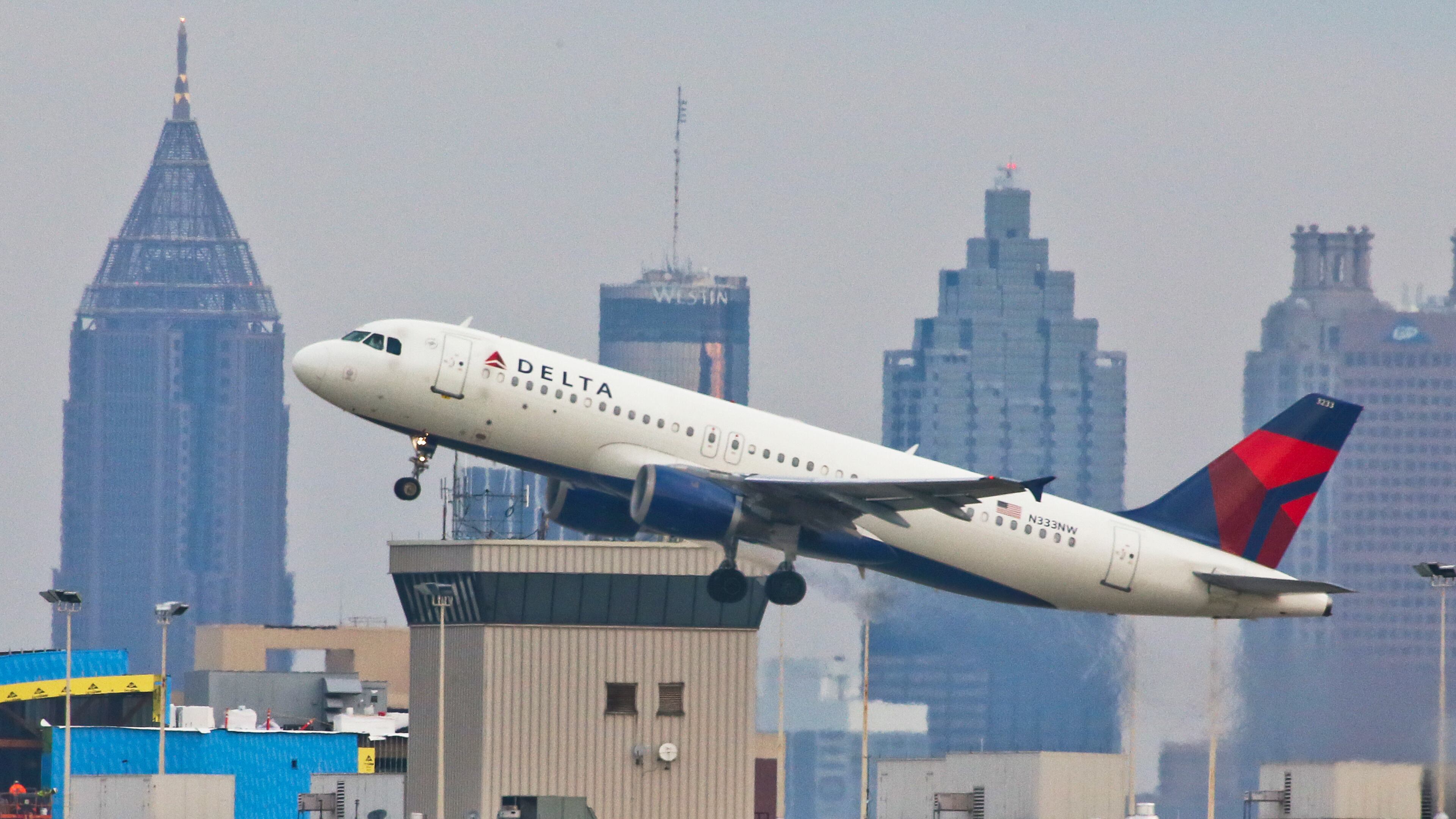 With gray skies over the Atlanta skyline a Delta jet takes off on Tuesday, Oct. 30, 2012. JOHN SPINK / JSPINK@AJC.COM