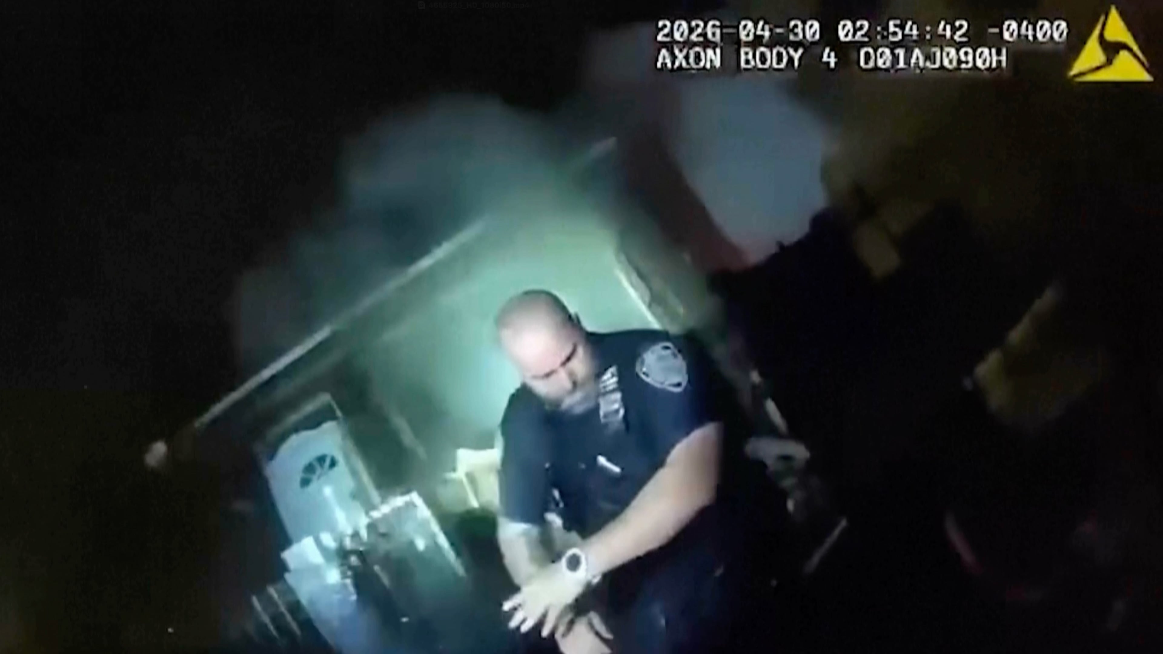 This image made from New York Police Department body camera video shows an officer after an explosion at a house while responding to a call of an armed man Thursday, April 30, 2026, in the Queens borough of New York. (New York Police Department via AP)