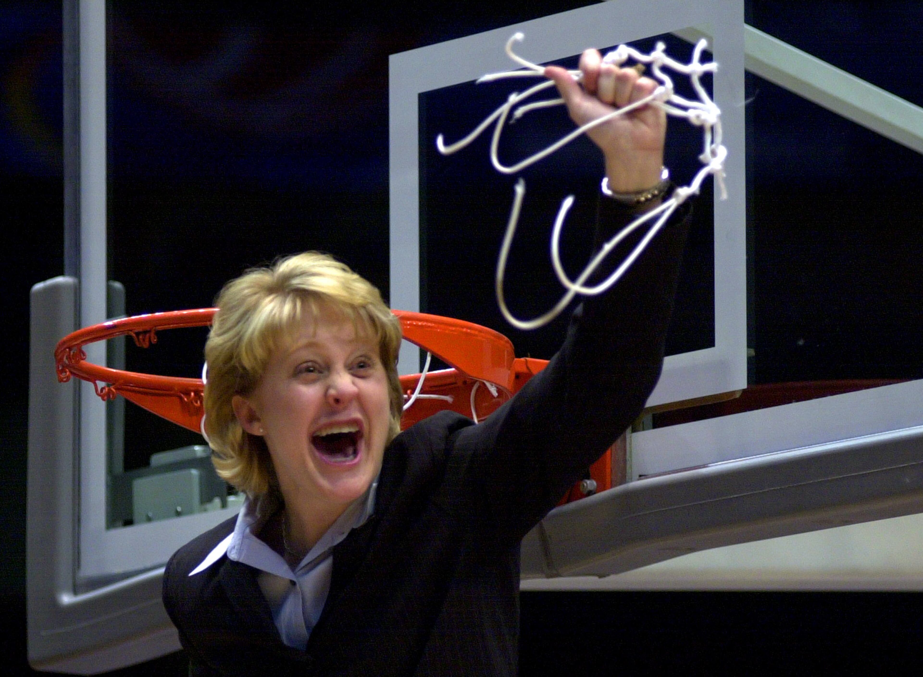 Purdue coach Kristy Curry reacts after cutting down the net following a 88-78 win over Xavier in the NCAA Women's Mideast Regional final at the Birmingham-Jefferson Civic Center in Birmingham, Ala. on Monday, March 26, 2001. Purdue advances to the Final Four. (AP Photo/Dave Martin)