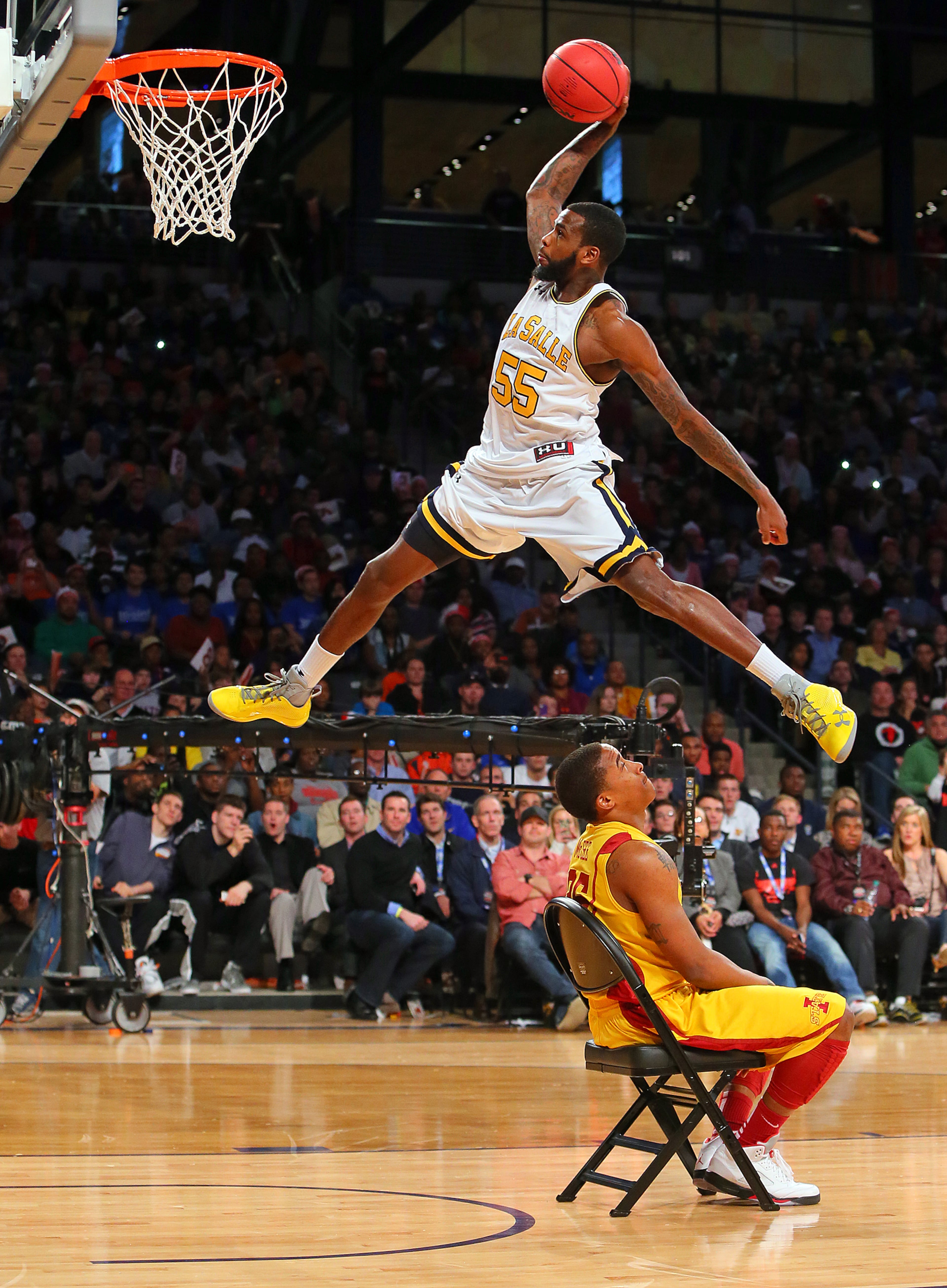 Ramon Galloway, La Salle University, climbs the stairs over a chair for a slam in the 25th annual State Farm College Slam Dunk & 3-Point Championships at McCamish Pavilion on Thursday, April 4, 2013, in Atlanta. Galloway finished third in the Slam Dunk Championship which was won by Doug Anderson from the University of Detroit Mercy. CURTIS COMPTON / CCOMPTON@AJC.COM