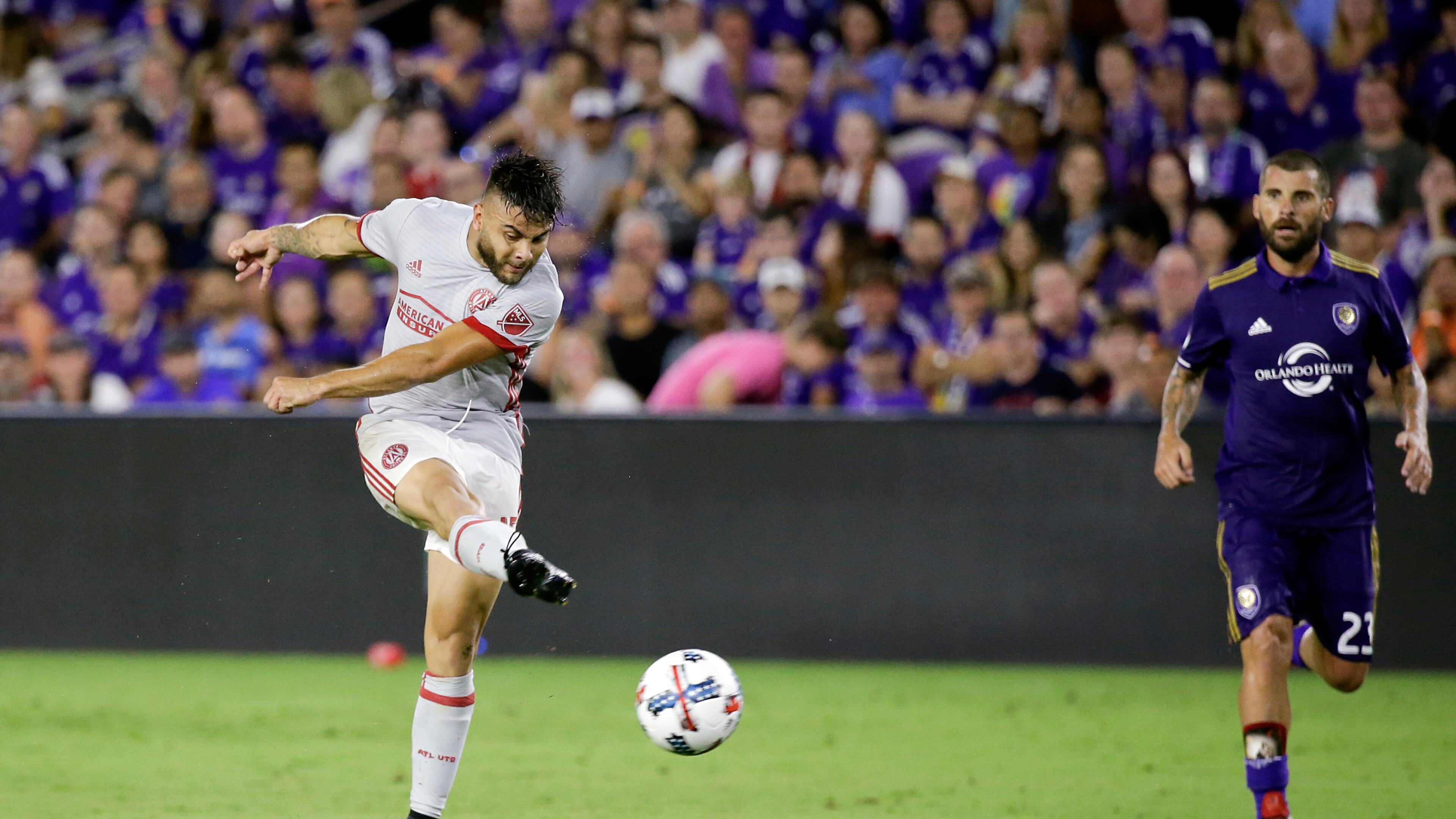 Atlanta United's Hector Villalba, left, scores a goal as Orlando City's Antonio Nocerino (23) watches during the second half of an MLS soccer match, Friday, July 21, 2017, in Orlando, Fla. Atlanta United won 1-0. (AP Photo/John Raoux)