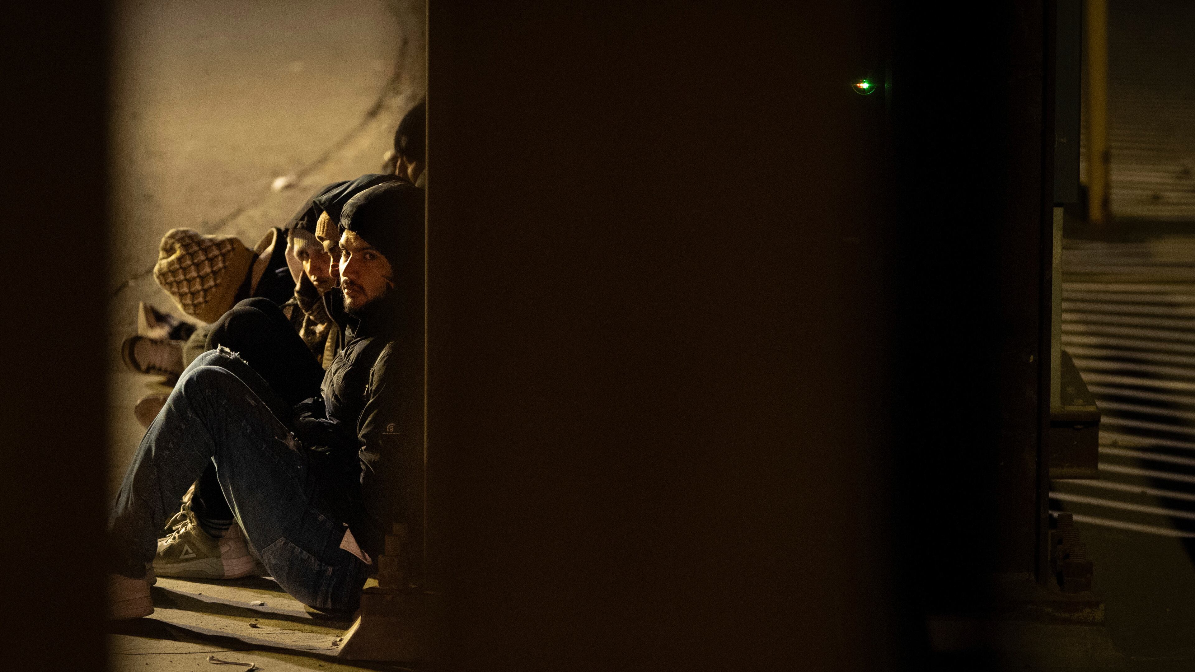 FILE - A group of migrants wait to be processed between two border walls separating Mexico and the United States after crossing illegally before dawn, Jan. 21, 2025, in San Diego. (AP Photo/Gregory Bull, File)