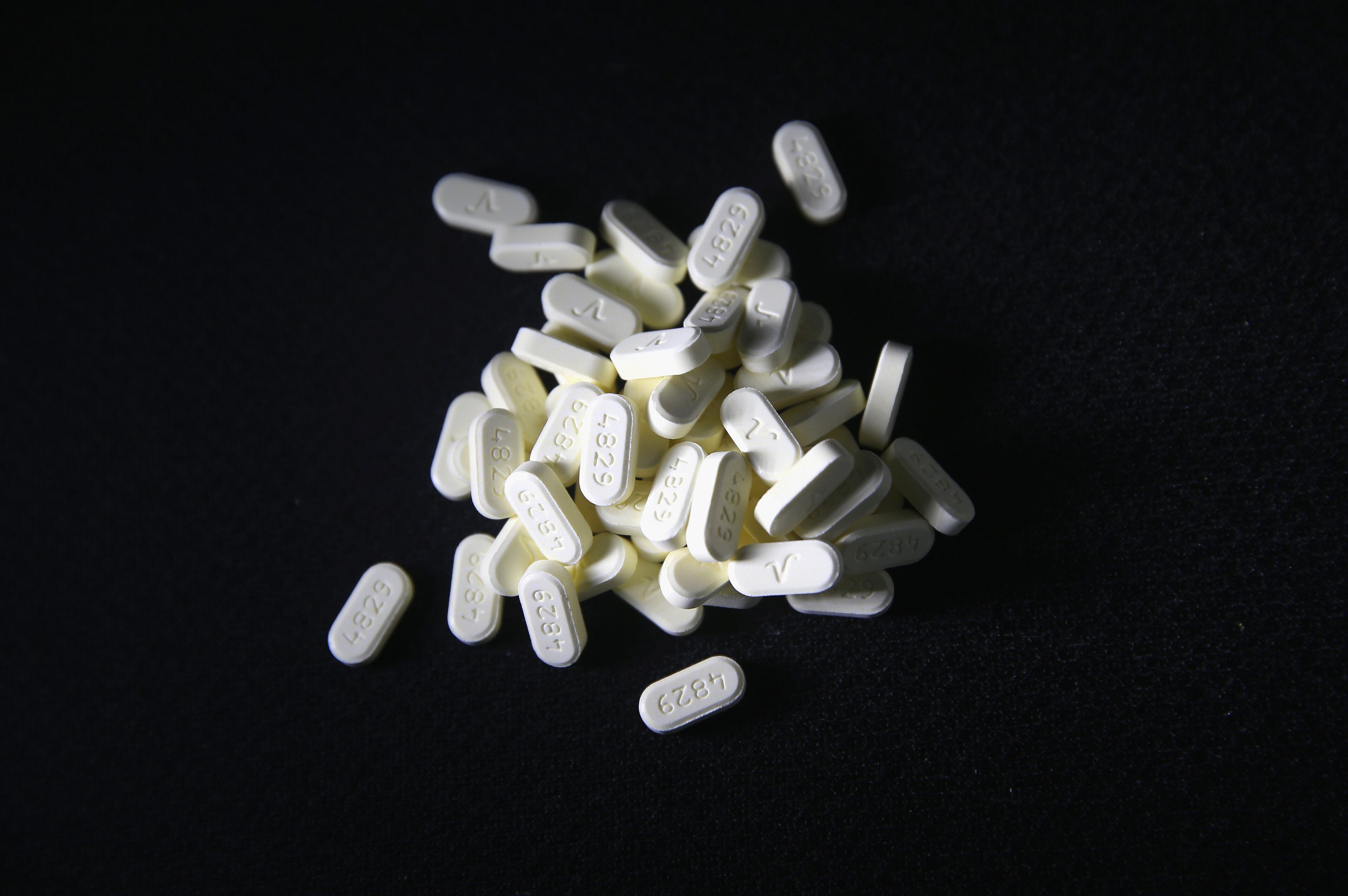 Oxycodone pain pills prescribed for a patient with chronic pain lie on display on March 23, 2016 in Norwich, Connecticut. The Atlanta-based CDC estimates that most new heroin addicts first became hooked on prescription pain medication before graduating to heroin, which is stronger and cheaper.