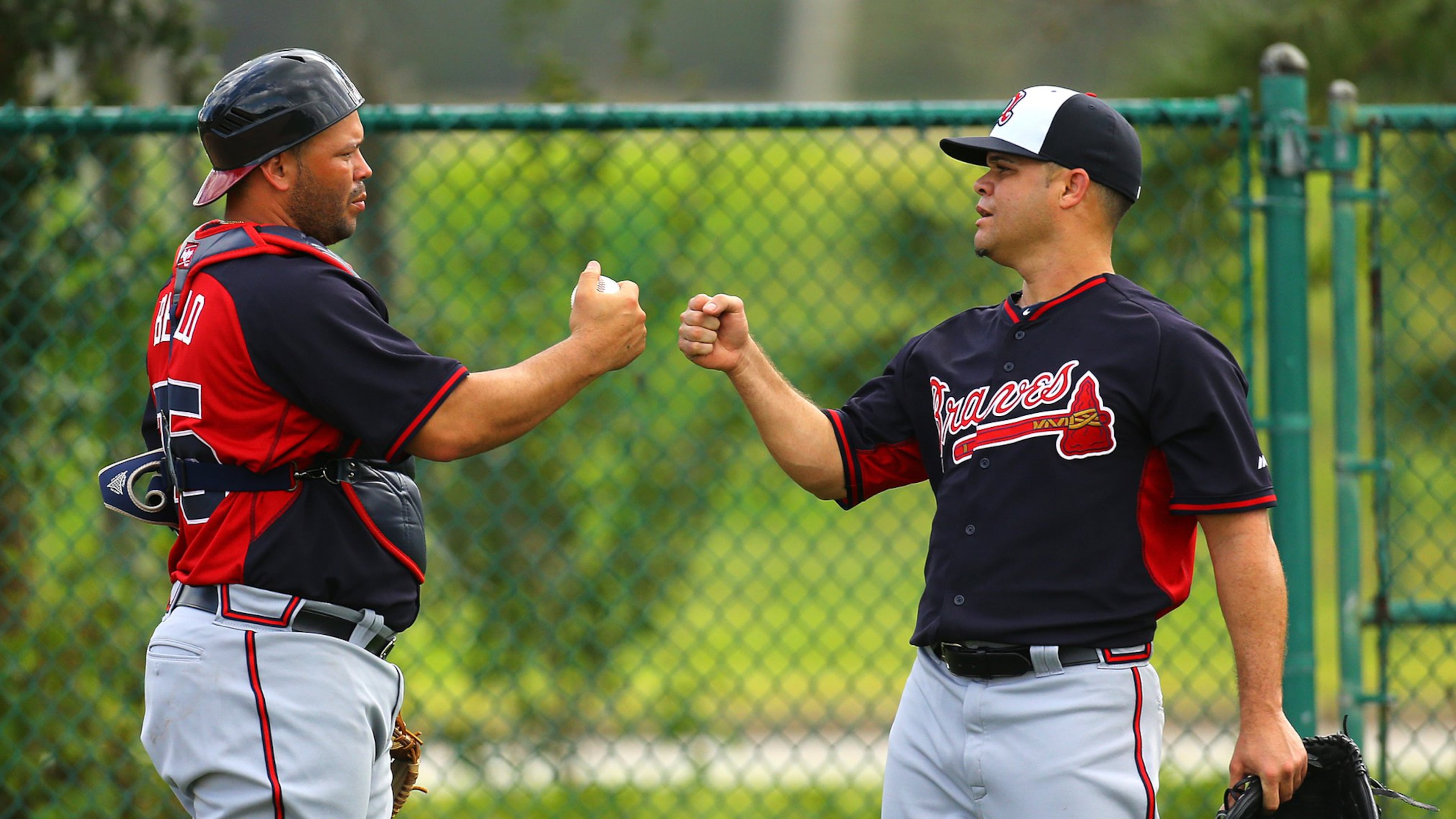 Wandy Rodriguez, shown bumping fists with catcher Yenier Bello after a spring-training workout, was released by te Braves on Friday. (Curtis Compton / ccompton@ajc.com)