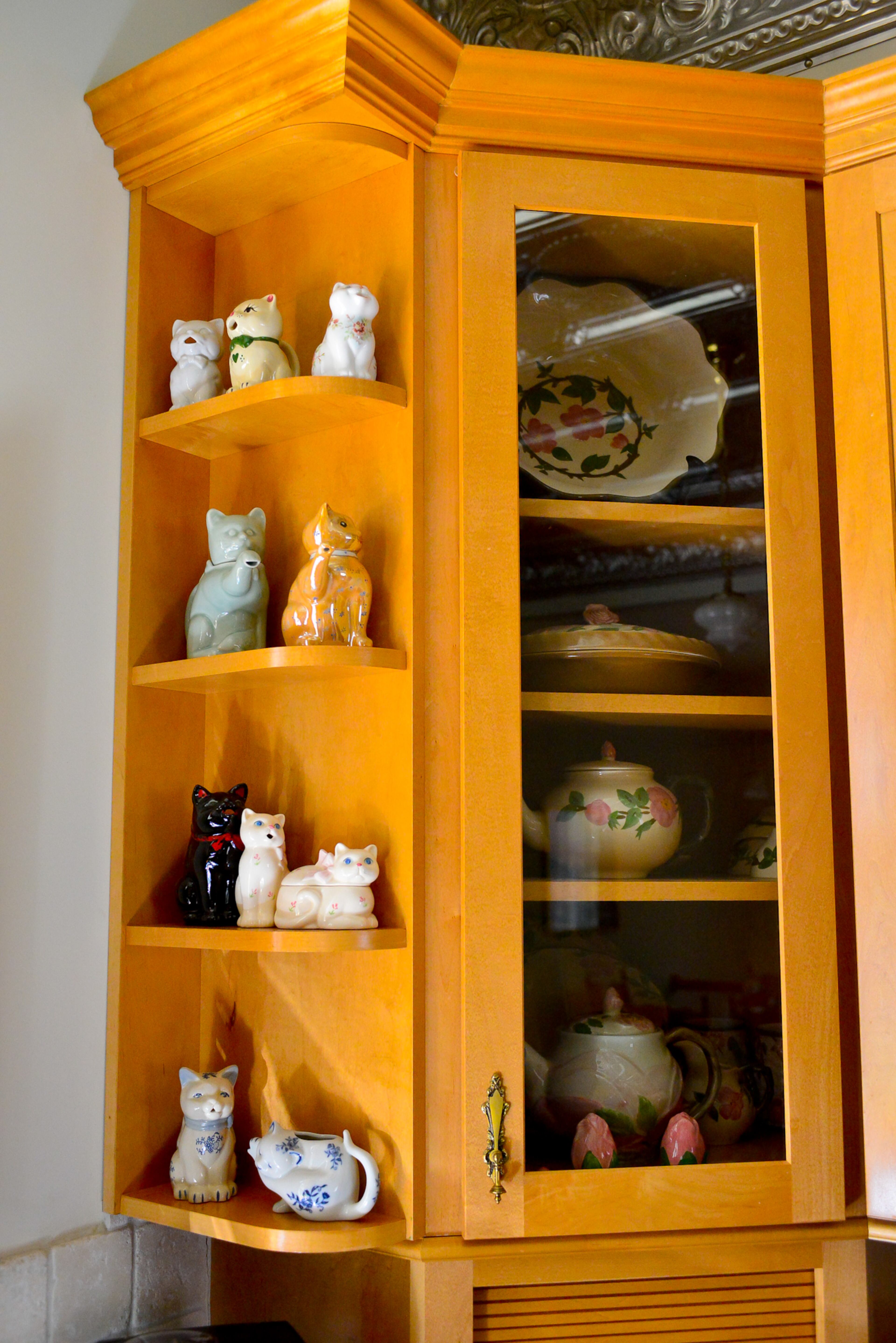 Mike and Carolyn Dufano's eclectic collections in their Grant Park home include kitten-themed creamer sets on display in their kitchen.