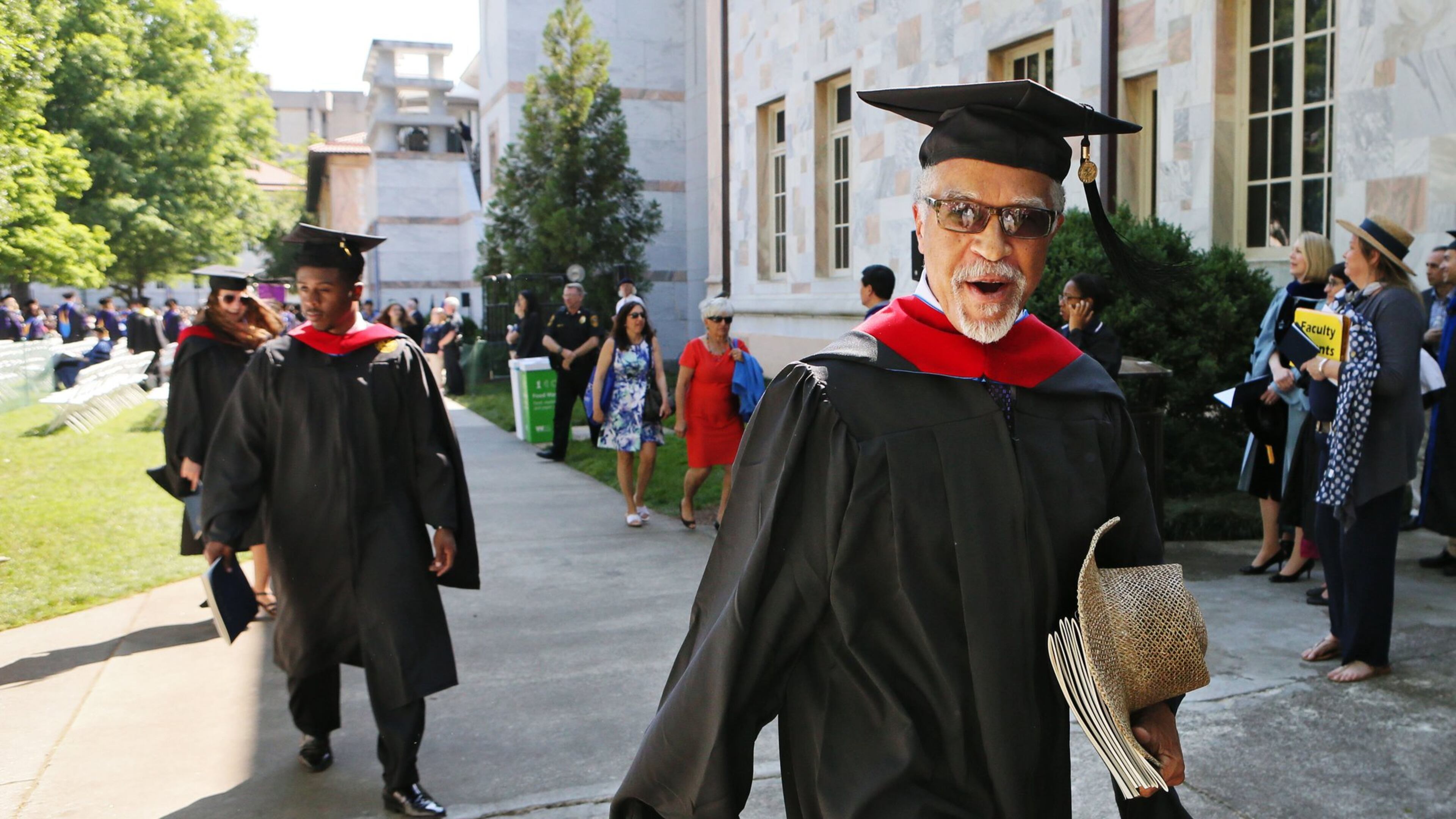 Hurl Taylor, 77, walks out with a big smile during the recessional on May 9. Decades after graduating from Emory Law, he received a master’s degree from Candler School of Theology to support his prison ministry. BOB ANDRES / BANDRES@AJC.COM