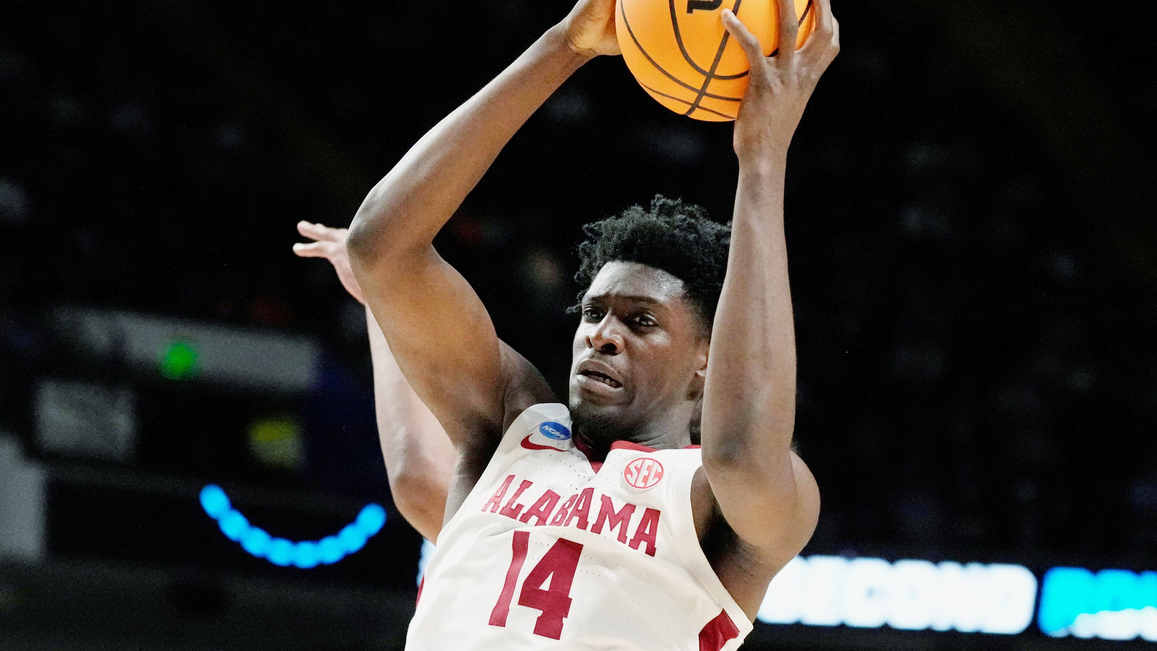 FILE - Alabama center Charles Bediako (14) pulls down a rebound while guarded by Maryland guard Ian Martinez, left, during the second half of a second-round college basketball game in the men's NCAA Tournament in Birmingham, Ala., March 18, 2023. (AP Photo/Rogelio V. Solis, File)