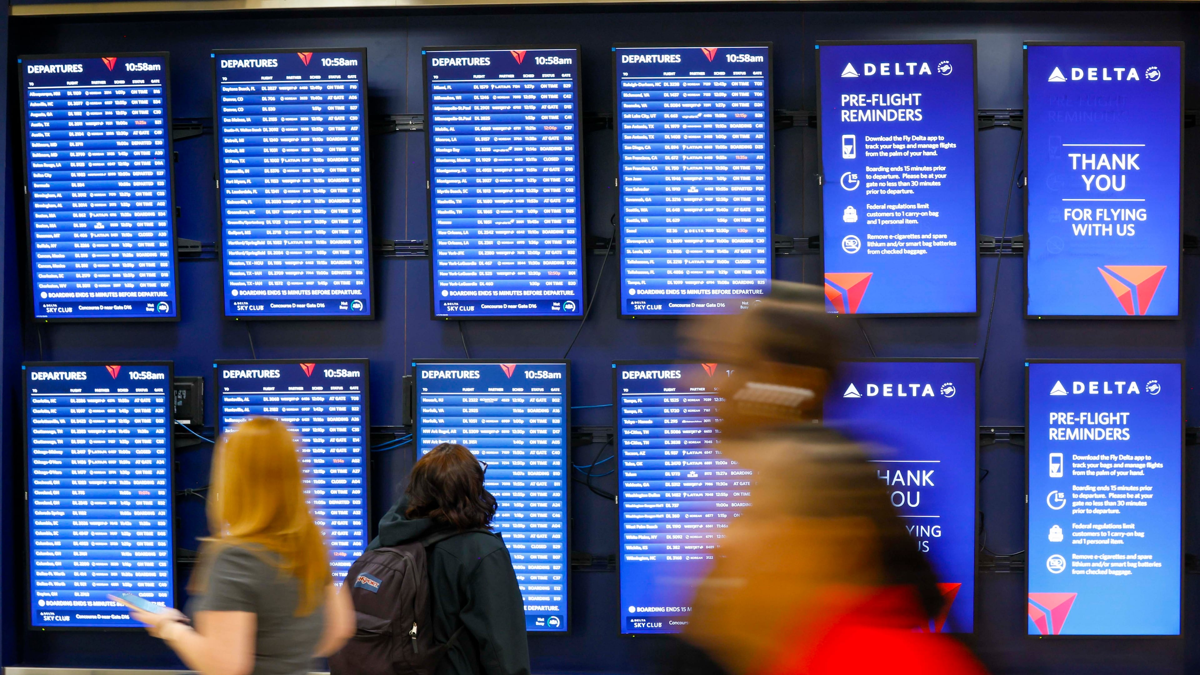 Travelers are seen looking at the monitors on Concourse D at the Hartsfield-Jackson Atlanta International Airport on Wednesday, Sept. 17, 2025. (Miguel Martinez/AJC)