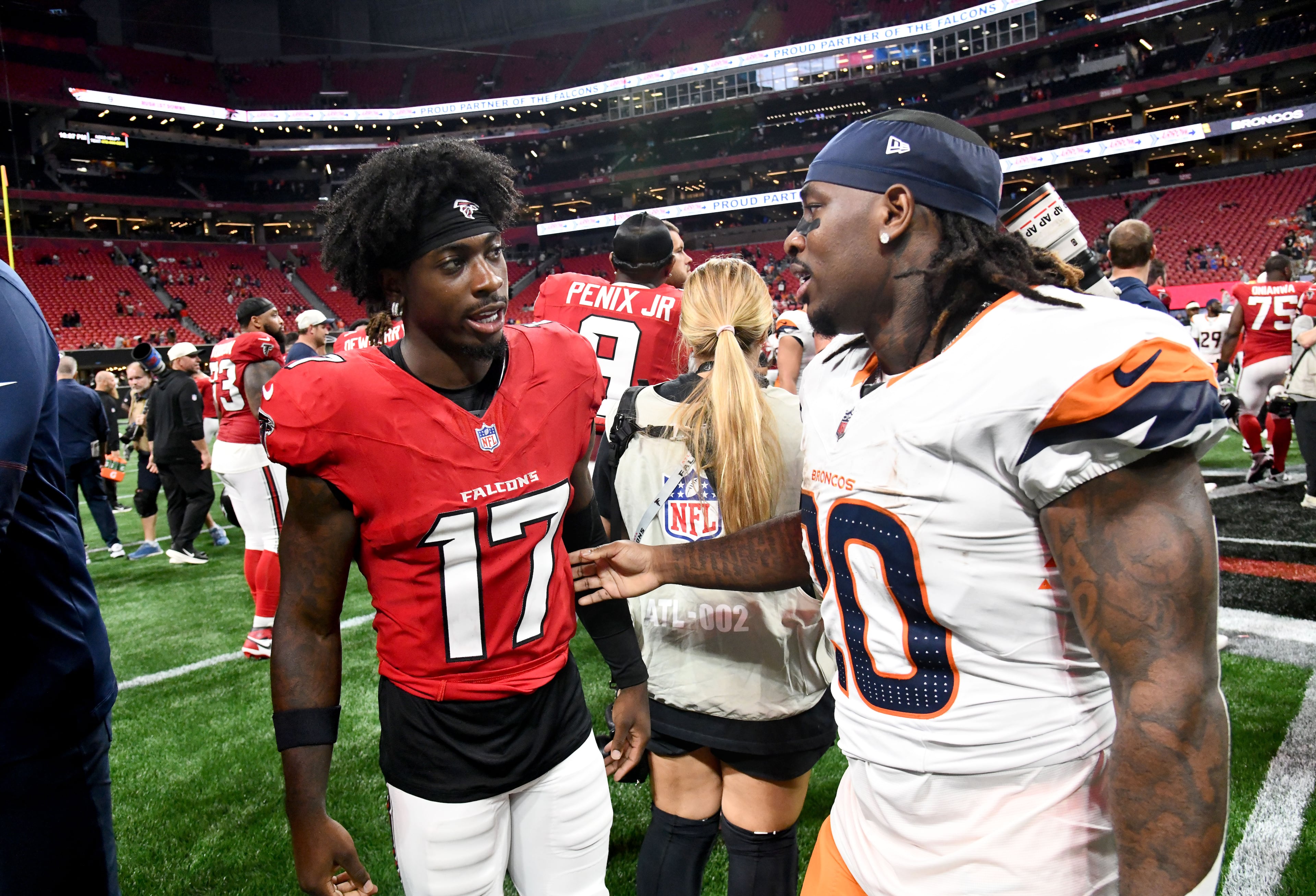 Falcons wide receiver Zachariah Branch (left) and Broncos running back Jonah Coleman greet each other after their preseason game at Mercedes-Benz Stadium on Friday, Aug. 14, 2026, in Atlanta. (Hyosub Shin/AJC)