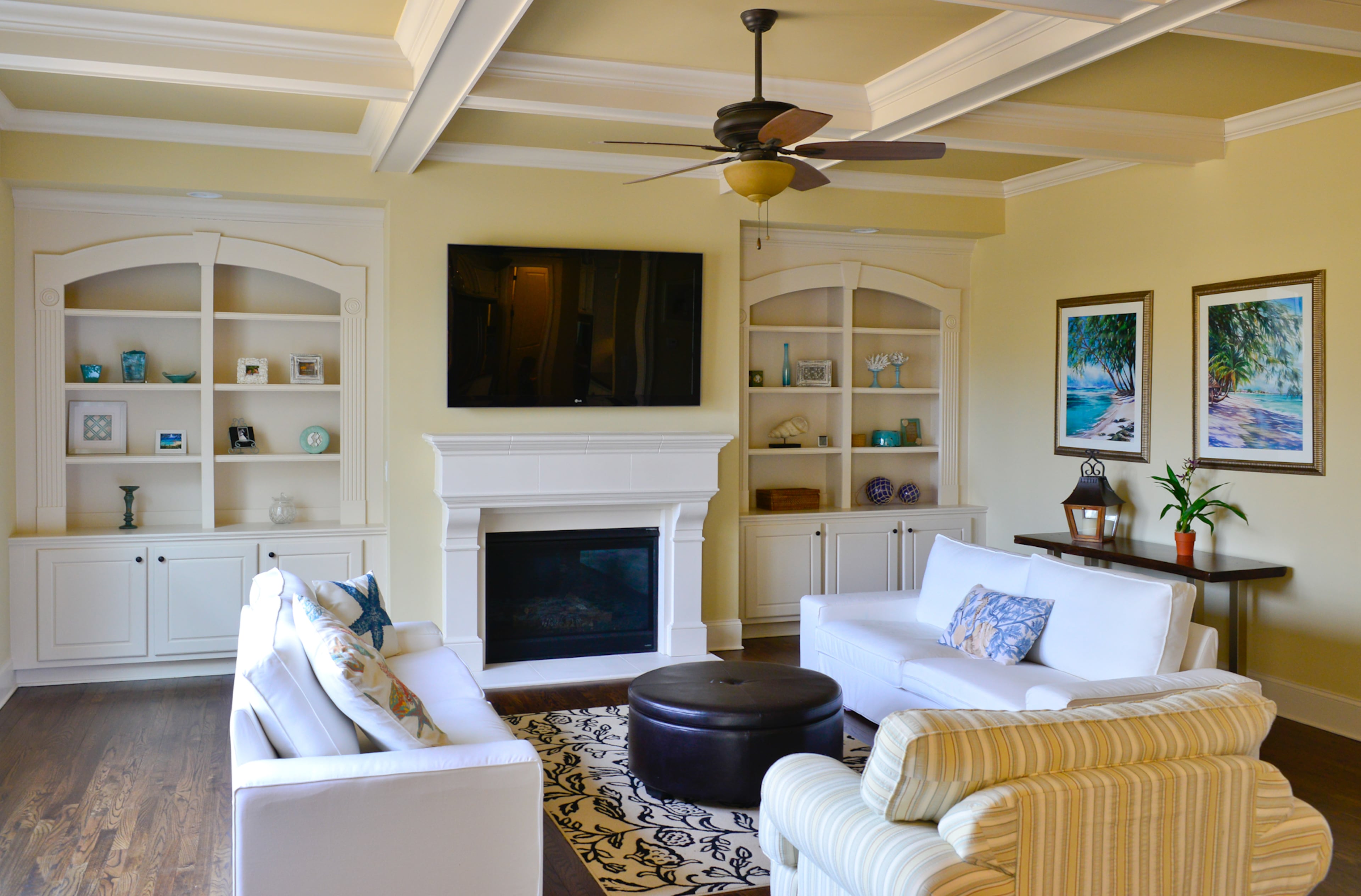 Couches from Ikea - that have washable covers - a chair the family has had for a while, an ottoman that was ordered online and a table from The Dump fill out the living room, which includes built-in bookcases, a coffered ceiling and a fireplace. Interior design style: Traditional with island inspiration.