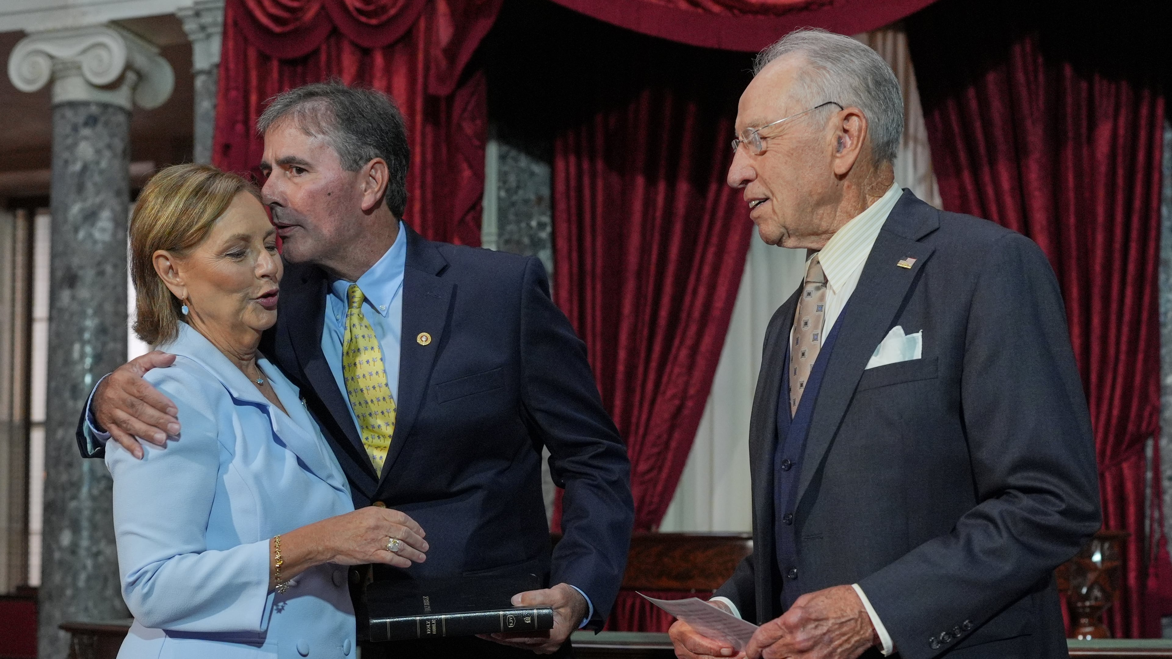 Sen. Darline Graham, R-S.C., sister of Sen. Lindsey Graham, R-S.C., is ceremonially sworn-in by President Pro Tempore of the Senate, Chuck Grassley, R-Iowa, in the Old Senate Chamber at the Capitol in Washington, Tuesday, July 14, 2026, as her husband Larry Nordone holds the Bible and gives her a kiss. (AP Photo/J. Scott Applewhite)