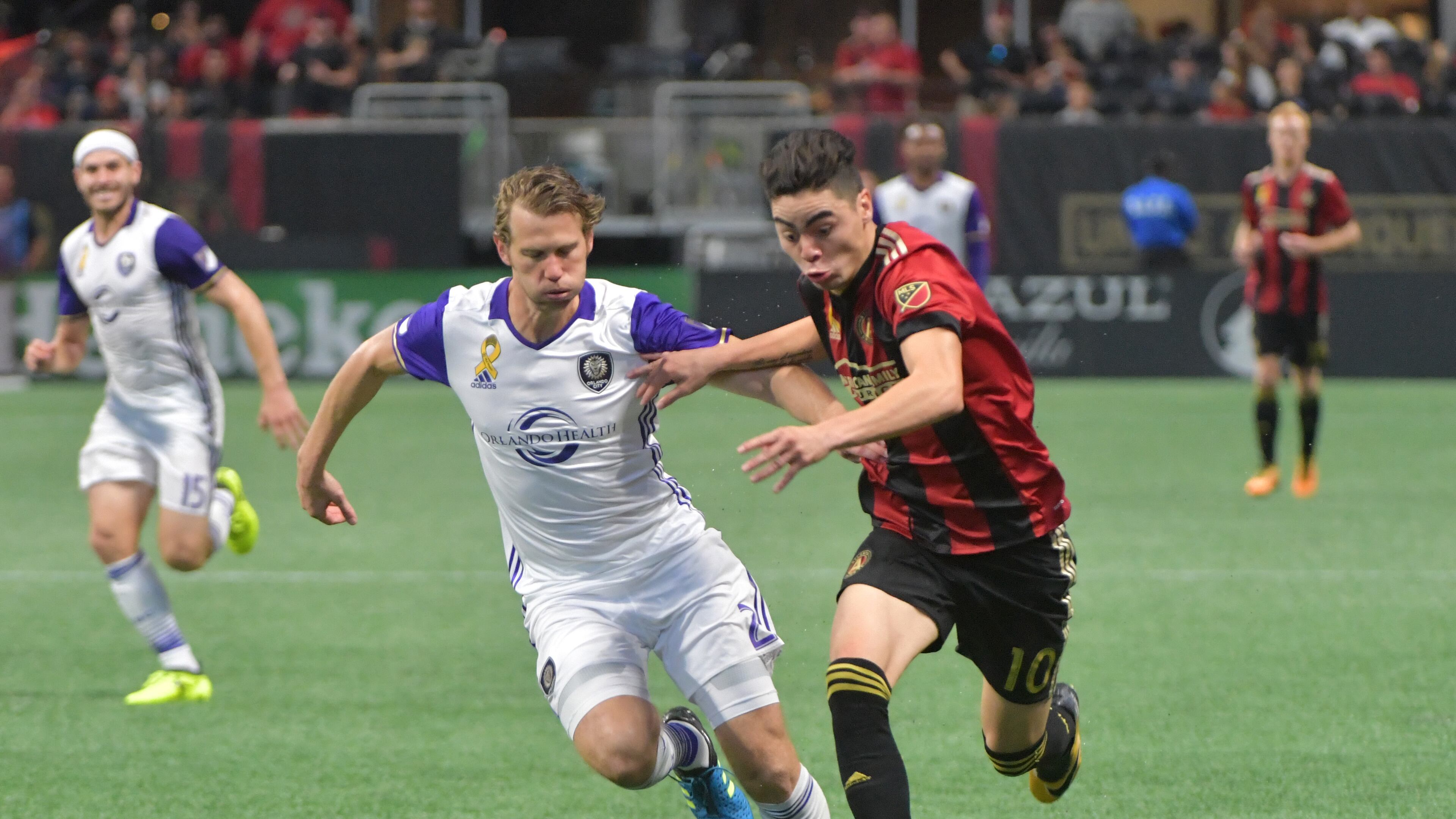 Orlando City SC defender Jonathan Spector (2) challenges Atlanta United midfielder Miguel Almiron (10) in the second half of an MLS soccer match at the Mercedes-Benz Stadium on Saturday, September 16, 2017.