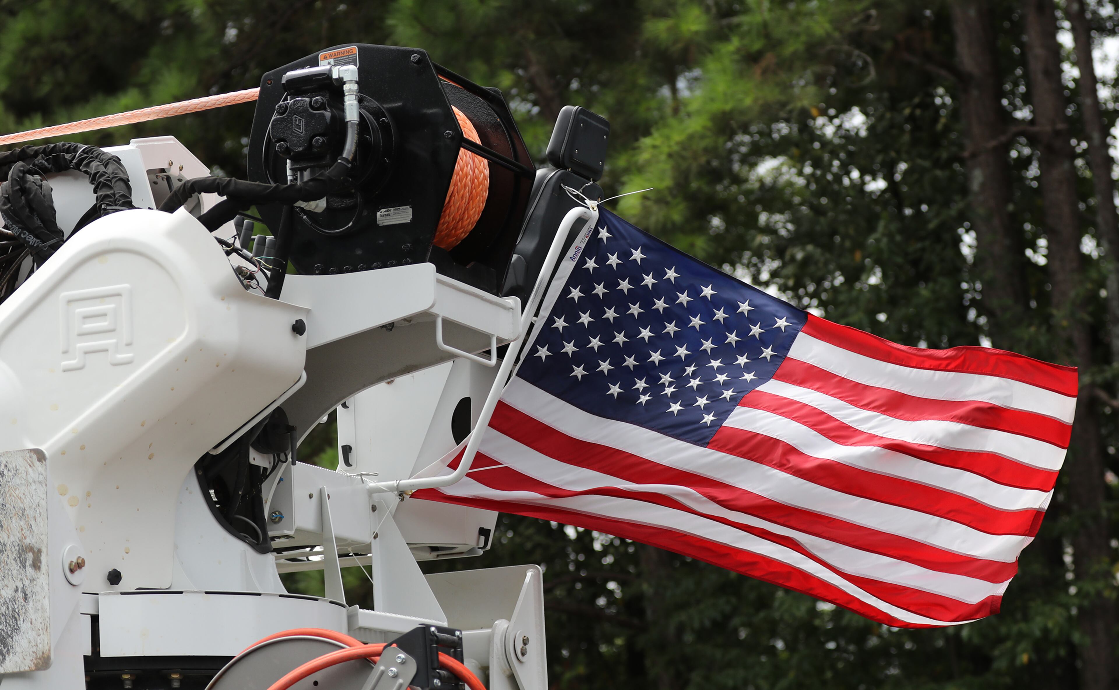 A American flag flys from a utility truck as a crew heads south on I-75 South through Macon in preparation for Hurricane Dorian on Sunday, Sept. 1, 2019, in Macon. (Photo: Curtis Compton/ccompton@ajc.com)