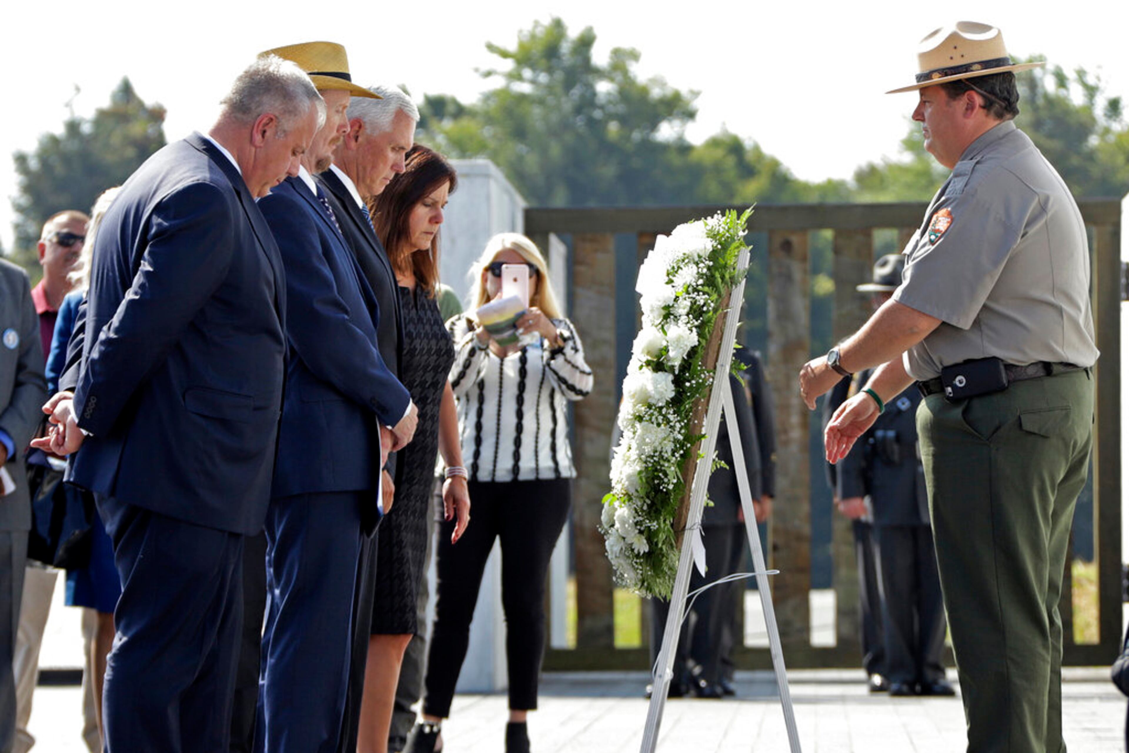 Vice President Mike Pence, third from left, and second lady Karen Pence, fourth from left, are joined by President of Families of Flight 93, Gordon Felt, second from left, and Secretary of the Interior David Bernhardt, left, in placing a wreath at the Wall of Names following the September 11th Flight 93 Memorial Service at the Flight 93 National Memorial in Shanksville, Pa., Wednesday, Sept. 11, 2019, the 18th anniversary of the attacks. Felt's brother Edward Felt was one of the 40 passenger and crew killed on Flight 93. (AP Photo/Gene J. Puskar)