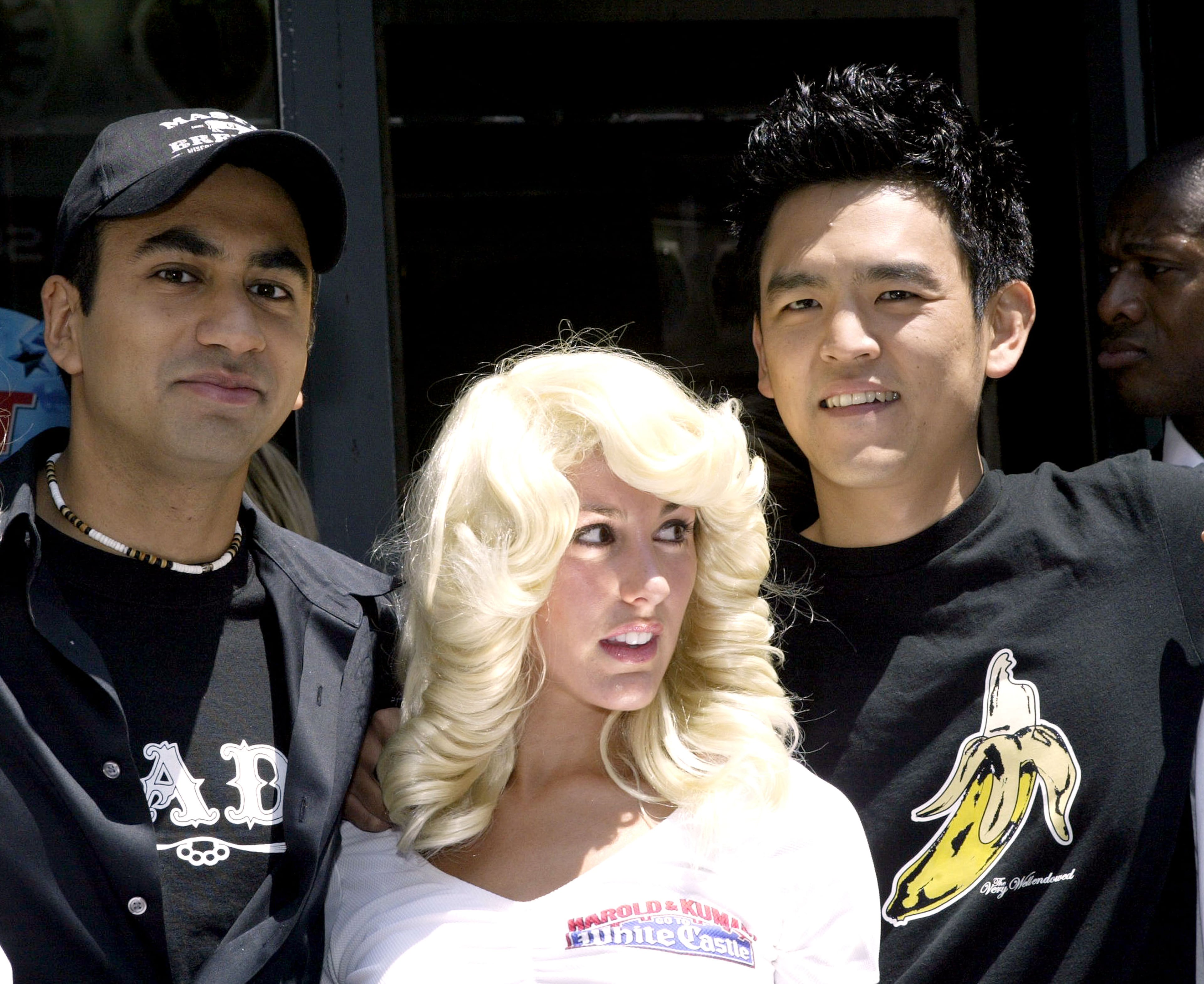 (L-R) Kal Penn and John Cho promote their new movie "Harold & Kumar Go to White Castle" with a White Castle waitress at Planet Hollywood July 20, 2004 in New York City. (Photo by Paul Hawthorne/Getty Images)