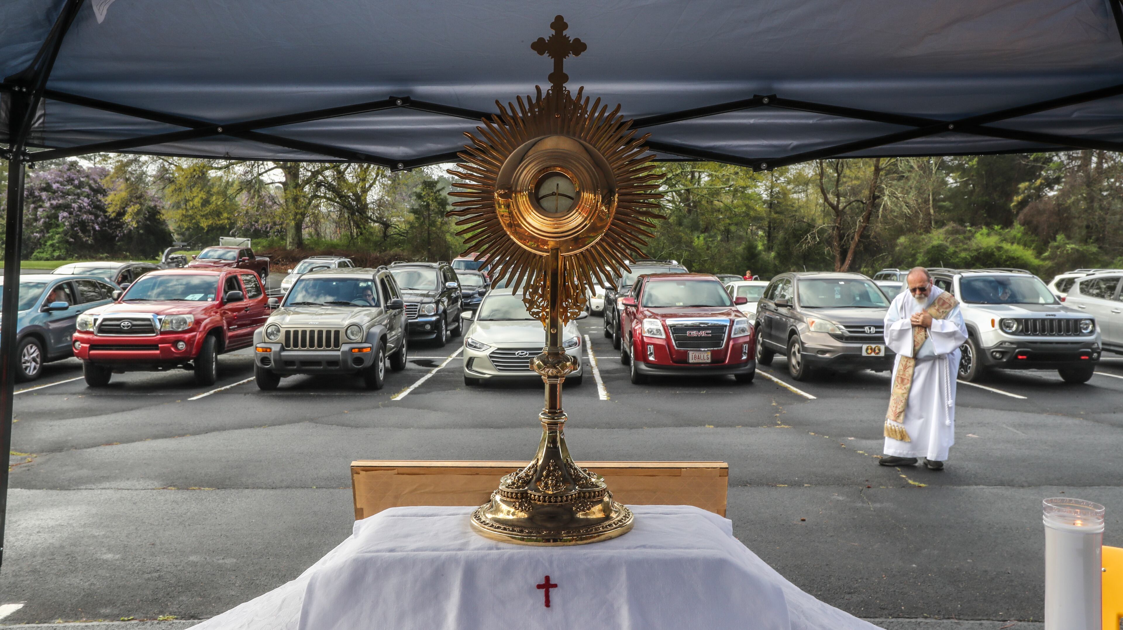 Deacon Fred Johns presided over “Drive-In” Adoration of the Blessed Sacrament Wednesday, March 25, 2020, where some 50-cars attended in the parking lot at St. Pius X Catholic Church in Conyers. Adoration is offered every day from 9 am to 10 am, A large consecrated host (bread wafer) from the Mass which Catholics believe is the Real presence of Jesus Christ, is reserved in a vessel called a “Monstrance” where the faithful pray before. Normally Adoration occurs in small chapels outside the main sanctuary when Mass is not being celebrated. Since the COVID-19 outbreak, Catholics in the Atlanta Archdiocese and around the world have been implementing creative ways to serve the faithful. JOHN SPINK/JSPINK@AJC.COM