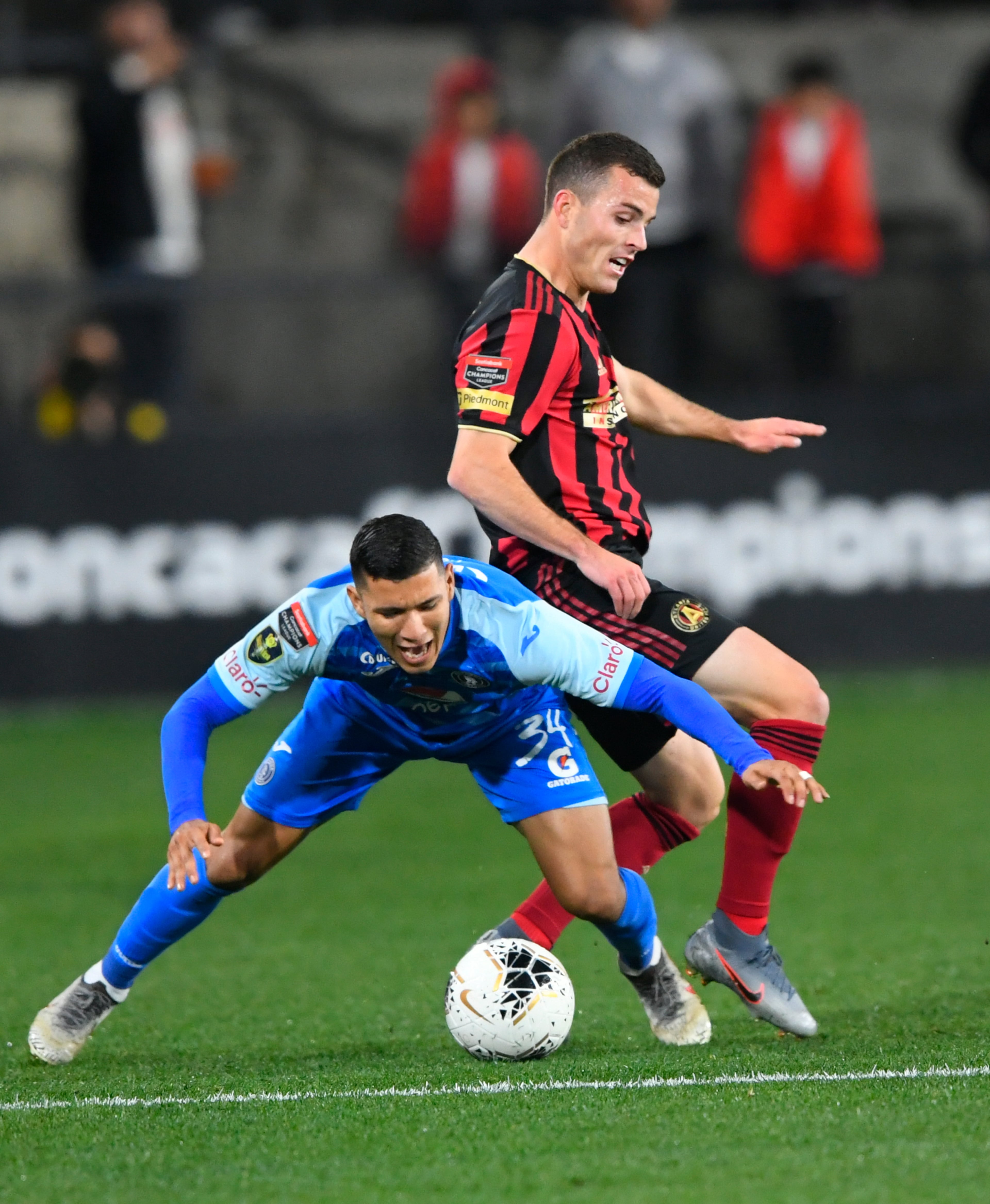 Motagua FCâs Kevin Lopez and Atlanta United defender Brooks Lennon, rear, battle for control of the ball during the first half of soccer in the Scotiabank Concacaf Champions League, Tuesday, Feb. 25, 2020, in Kennesaw, Ga. (John Amis, Atlanta Journal Constitution)