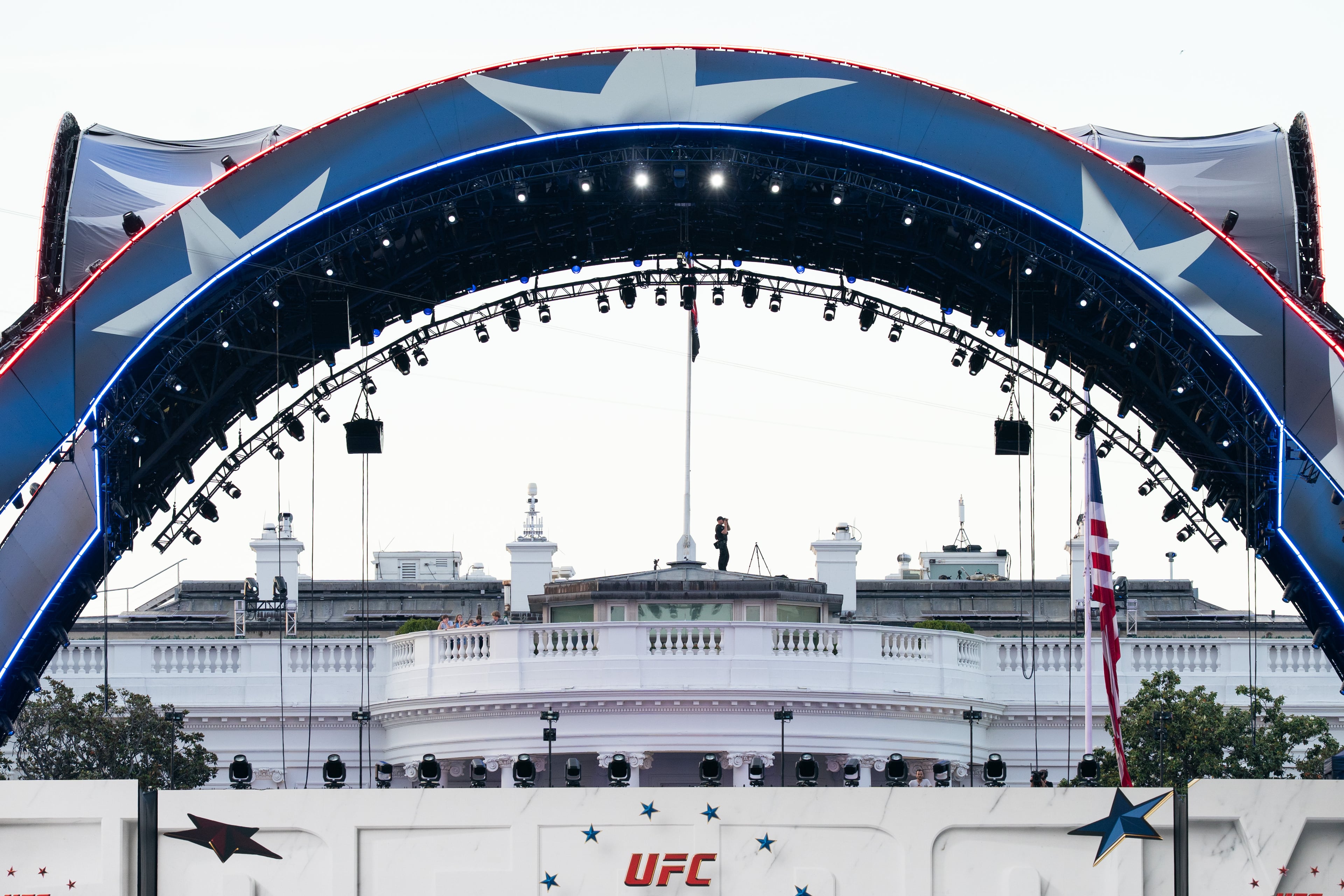 Security at the White House looks through a pair of binoculars during the UFC Fan Fest on the White House Ellipse ahead of Sunday’s fight on the South Lawn in Washington. (Allison Robbert/AP)