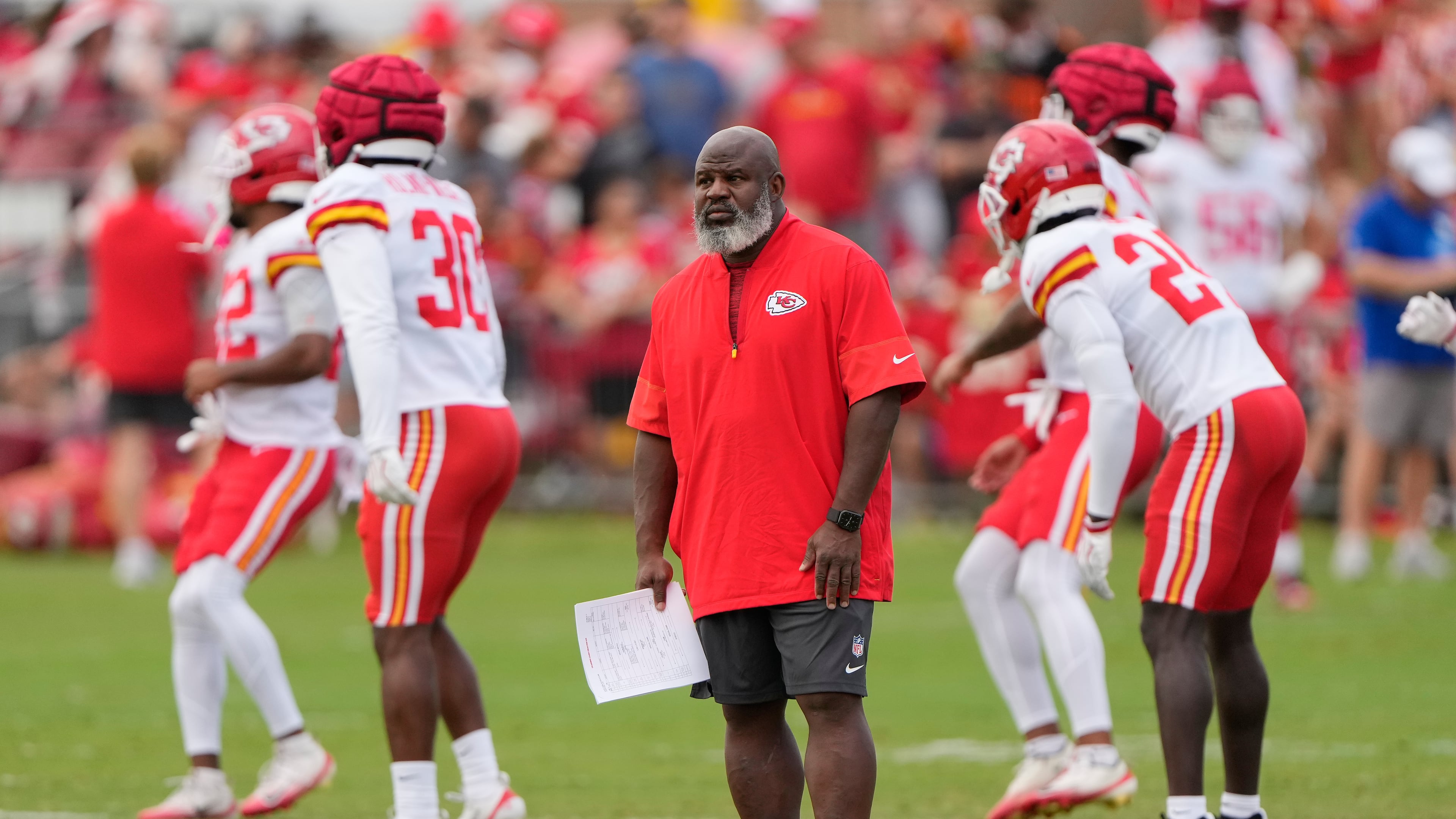 Kansas City Chiefs offensive coordinator Eric Bieniemy watches NFL football training camp Tuesday, Aug. 11, 2026, in St. Joseph, Mo. (AP Photo/Charlie Riedel)
