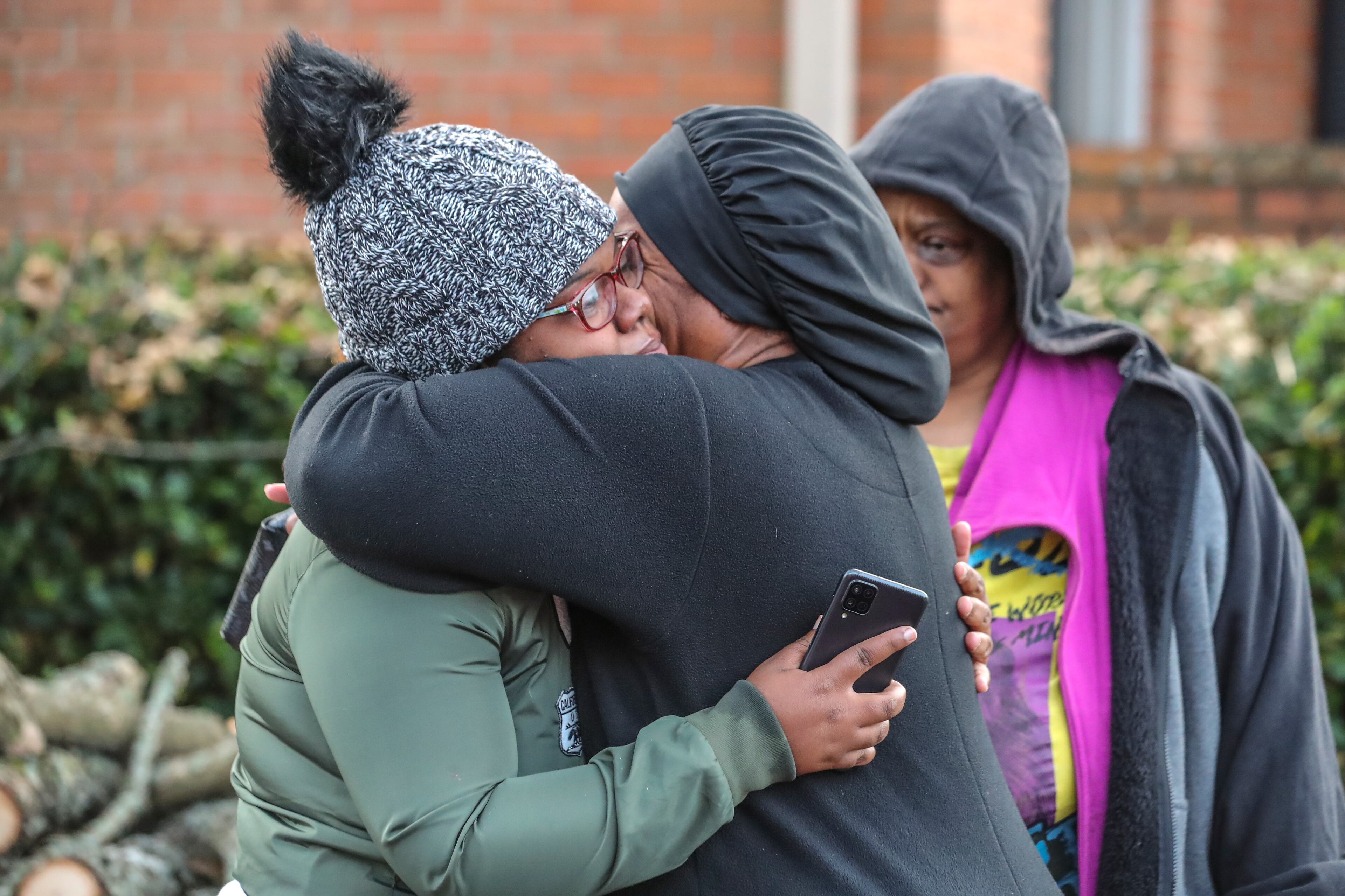November 10, 2021 DeKalb County: Deonna Bray (left) is hugged by Kenyatta Kinnemore (right) while waiting on news on Bray’s missing son, 1-year old Blaise Barnett who was taken when the car he was in was stolen while his parents were offloading groceries in front of their Clarkston apartments at Parc 1000 on 1000 Montreal Road. on Wednesday Nov. 10, 2021. It took maybe 30 seconds for the family of Blaise Barnett to take their eyes off the 1-year-old boy as they unloaded groceries Wednesday morning, and he was gone. In that time, someone climbed into the driver’s seat of their gray Ford Explorer and took off with the toddler, wearing only a diaper and a black shirt with blue dinosaurs, still strapped in his car seat. An Amber Alert was issued for the child early Wednesday, and neither he nor his family’s vehicle has been located in the nine hours since. “I just kept saying this is a dream. This just can’t be real,” his father, Xavier Barnett, told The Atlanta Journal-Constitution from outside his Clarkston apartment as the search continued. “I just broke down. Please, bring him home. The car don’t even matter, just bring my son home.” Blaise Barnett was reported missing at 1 a.m. from the Parc 1000 apartments at 1000 Montreal Road. According to a police report, Blaise’s parents were running bags of groceries to their apartment and returned to the parking lot to find their vehicle and their son gone. His father told police he carried his 3-year-old nephew inside first and was coming back for the toddler. “He was in there for probably like 30 seconds, maybe, and within those 30 seconds he came back outside and the car was gone with Blaise in it,” Deonna Bray, the child’s mother, told the AJC. The vehicle was not left running, but its keys were in the cupholder, according to the report. Blaise was strapped into a black and tan car seat and had a blanket wrapped around his legs, his parents told police. The GBI issued the alert, known as a Levi’s Call in Georgia, on behalf of the Clarkston Police Department. The Barnett family said the toddler’s name was misspelled in the alert. There have been no sightings as of 10:30 a.m. Wednesday, and police have not located the vehicle on any surveillance cameras in the area. Investigators have not developed any leads, Clarkston police Chief Christine Hudson told reporters as the search entered the 10th hour. The police department has devoted all of its resources, including patrol officers and detectives, to canvassing the area. DeKalb County police, the GBI and the FBI are also out looking for Blaise. “This is now a nationwide search,” the chief said, adding she wished she had more to give the Barnett and Bray families. “Waiting, that is the hardest part,” Deonna Bray said. “Not knowing. The waiting.” Blaise is believed to be traveling in the gray 2002 Ford Explorer, which has a temporary Georgia tag P2722946. According to the police report, there are wooden sticks holding up two back windows. Anyone who spots the child or the vehicle is asked to call Clarkston police at 404-557-8956 or dial 911. (John Spink / John.Spink@ajc.com)