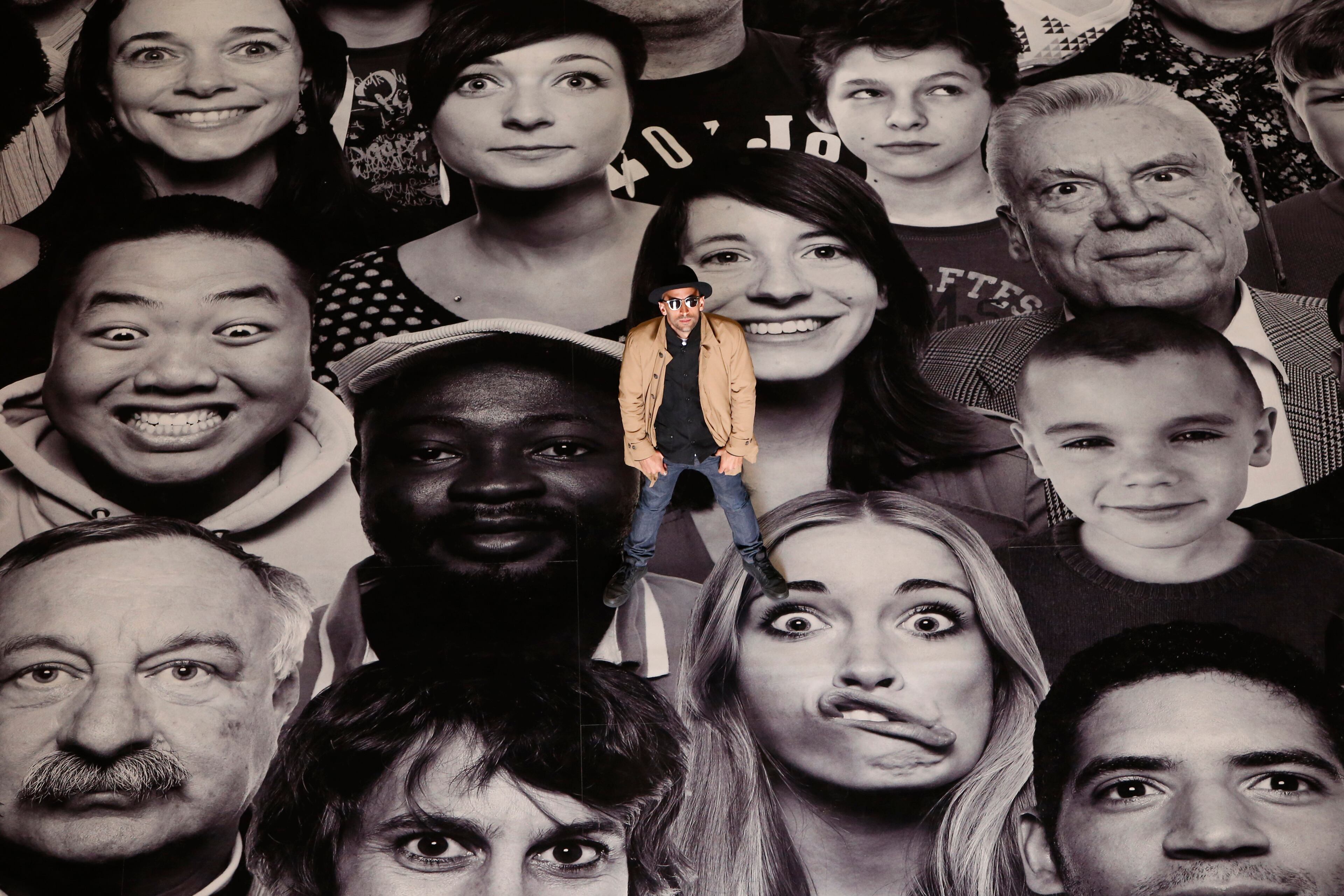 French street artist and photographer JR poses on his creation during the presentation to the press at the Pantheon in Paris, Tuesday, June 3, 2014. French Government named JR to decorate with portraits of Paris' Pantheon, that is the final resting place for 72 of France's renowned men, and just one woman, as the monument is undergoing a 2 year renovation. (AP Photo/Francois Mori)