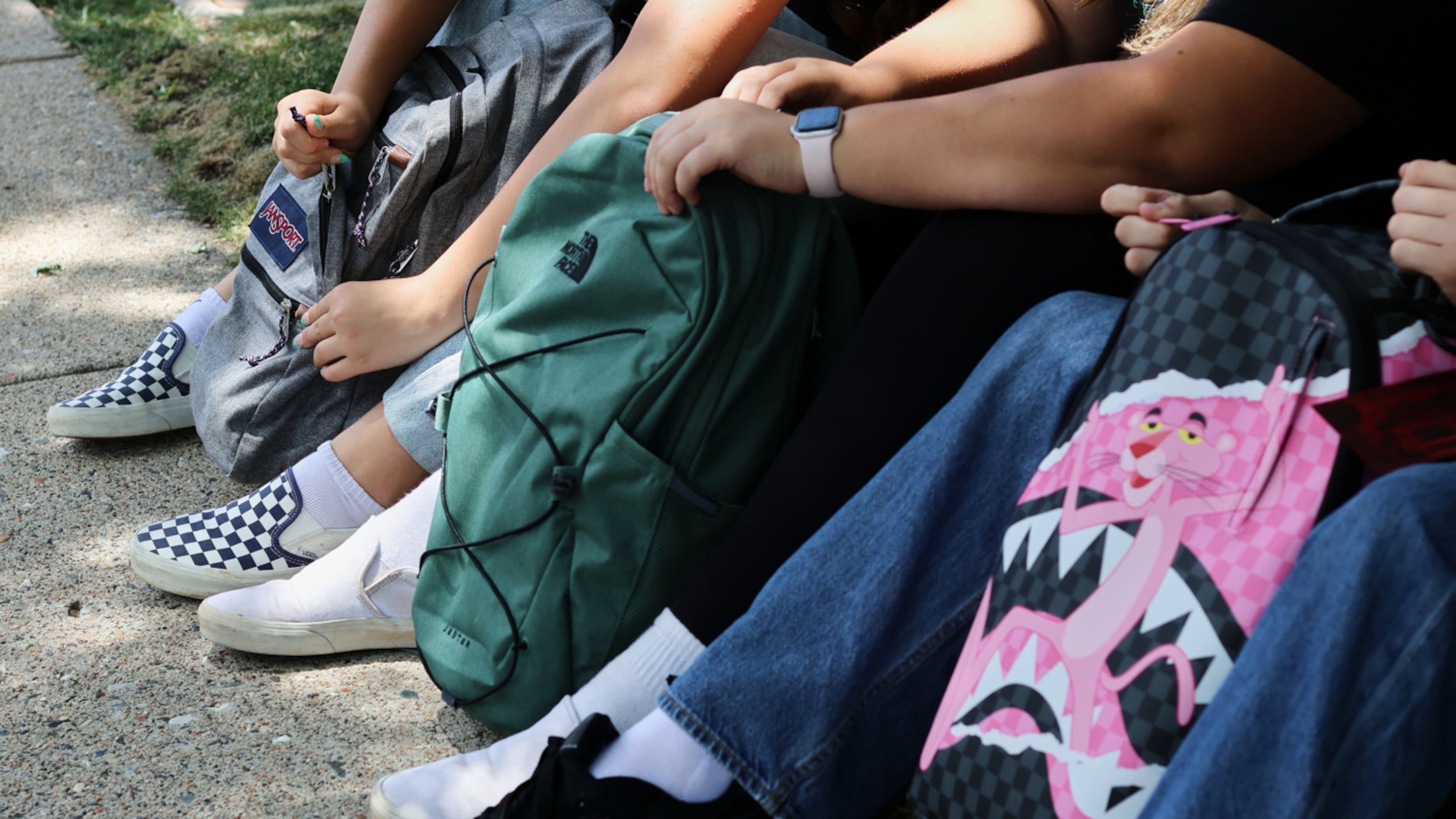 Middle school students Claire Knoth and Brockton Lozano and high school student Zoie Knoth share what is in their backpacks Friday, July 31, 2026, in Flagstaff, Ariz. (AP Photo/Cheyanne Mumphrey)