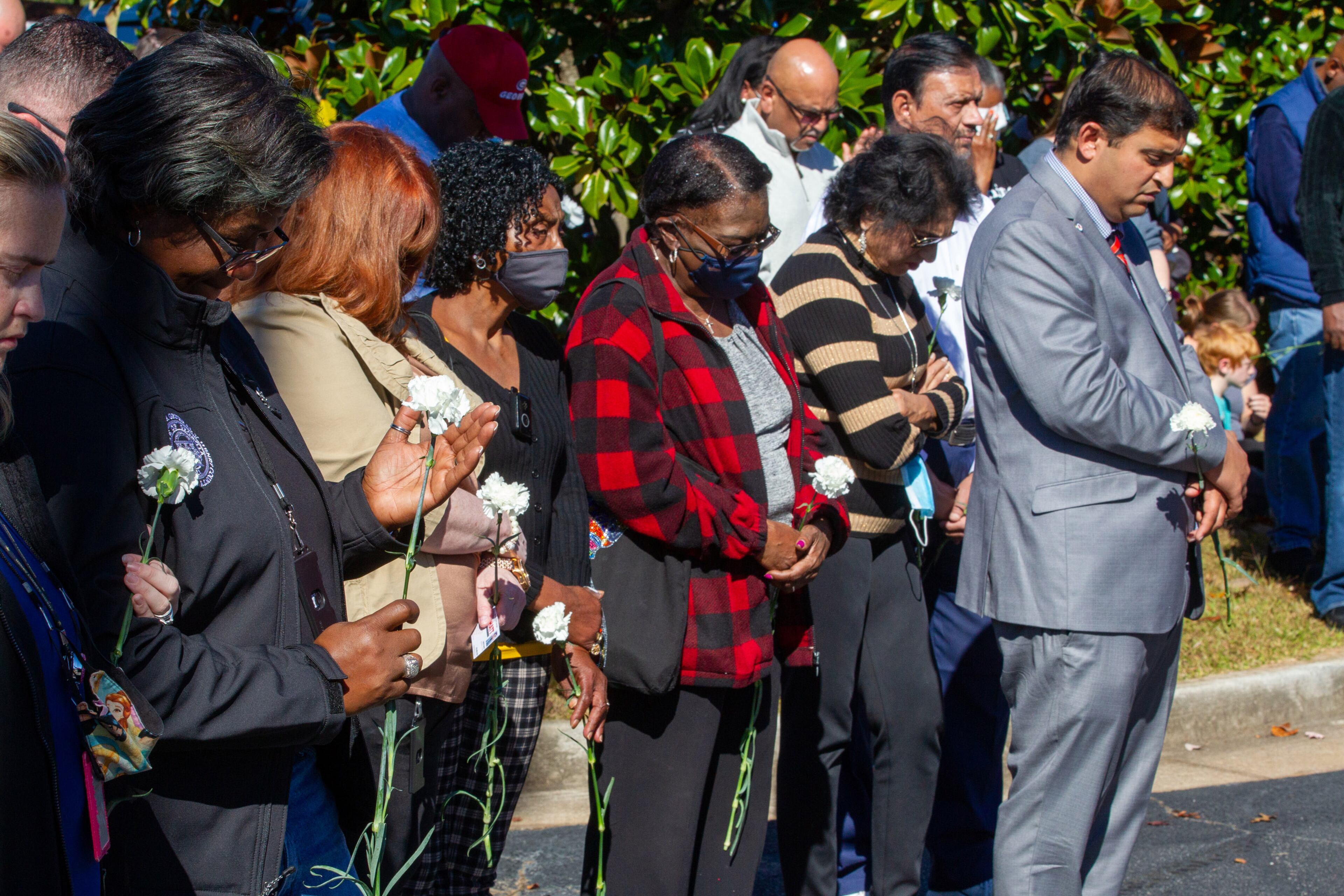 A crowd bows their head during a prayer vigil for Officer Paramhans Desai in McDonough on November 12, 2021. STEVE SCHAEFER FOR THE ATLANTA JOURNAL-CONSTITUTION