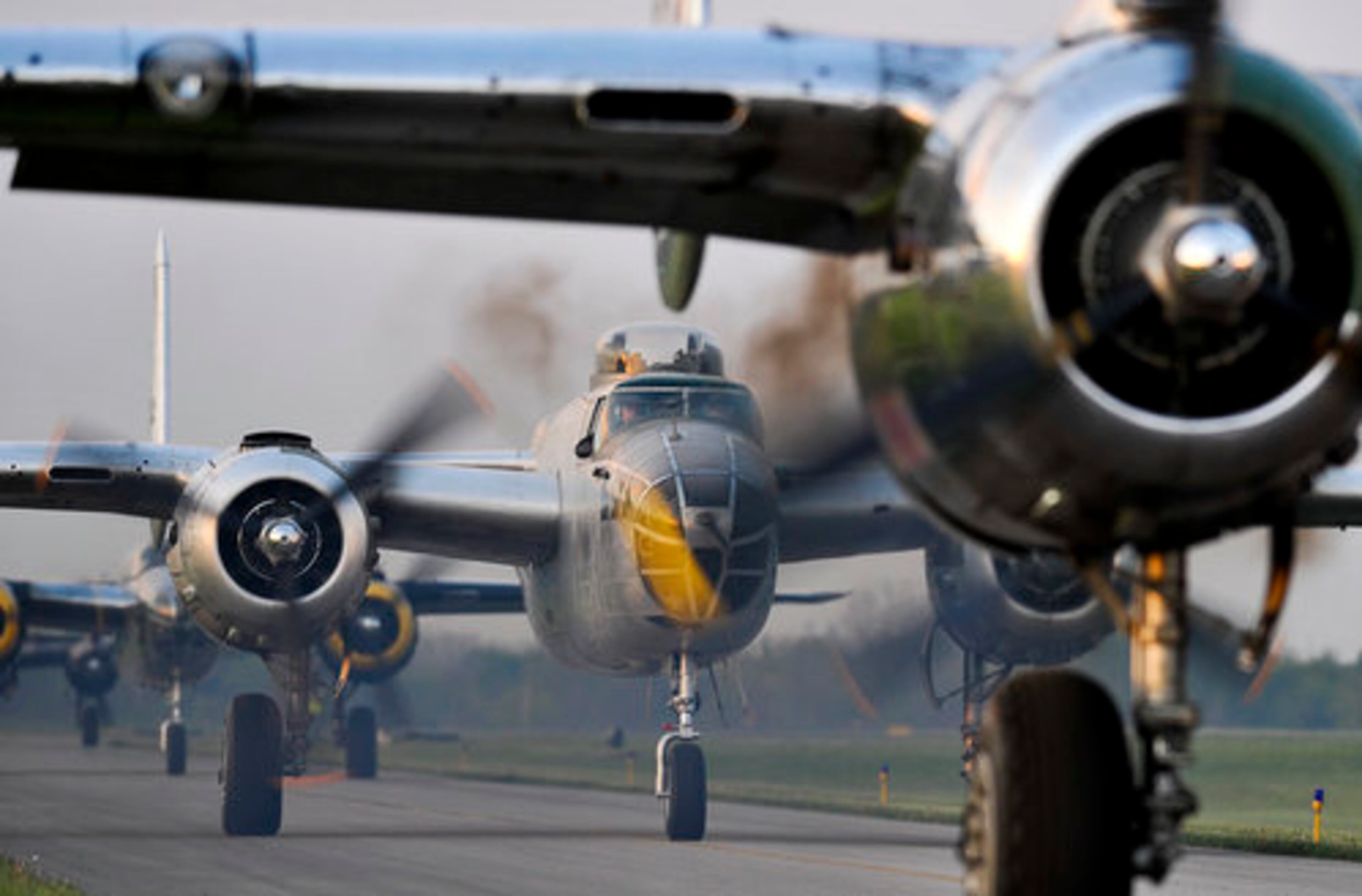 Twenty vintage B-25 bombers line up for take off at Grimes Field in Urbana Tuesday morning as they depart for Wright Patterson Air Force Base for the Doolittle Raiders Reunion. The planes have been staging in Urbana throughout the weekend so they could all fly into the reunion together. It is the largest gathering of the planes since WWII.
