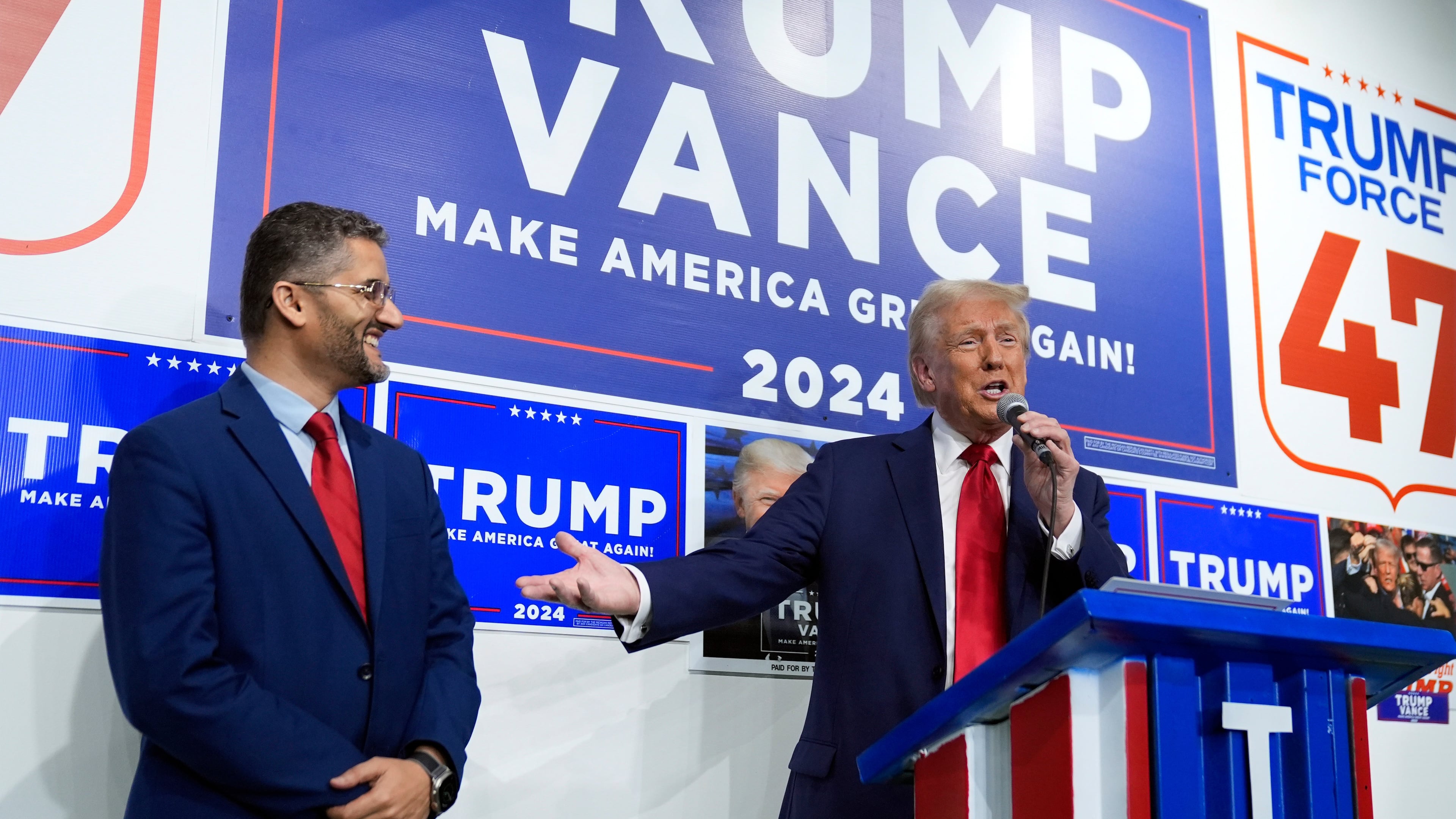 FILE - Republican presidential nominee former President Donald Trump speaks as Hamtramck Mayor Amer Ghalib listens at a campaign office, Oct. 18, 2024, in Hamtramck, Mich. (AP Photo/Evan Vucci, File)