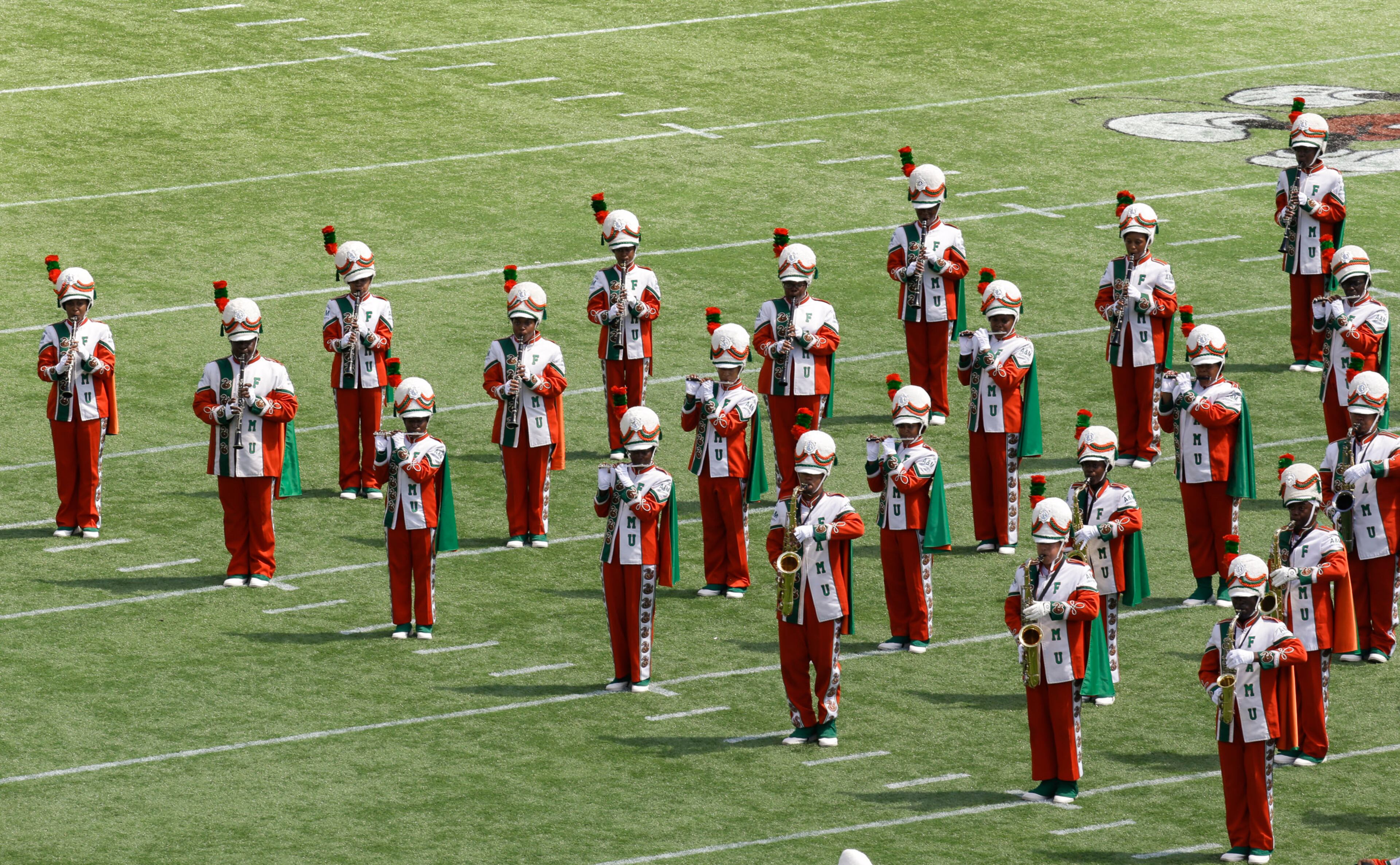 The Florida A&M University band performs Sunday, Sept. 1, 2013, in Orlando, Fla., for the first time in nearly 22 months. In 2011, all band performances were halted for FAMU's famed Marching 100 shortly after drum major Robert Champion collapsed and died following a hazing ritual. (AP Photo/John Raoux)