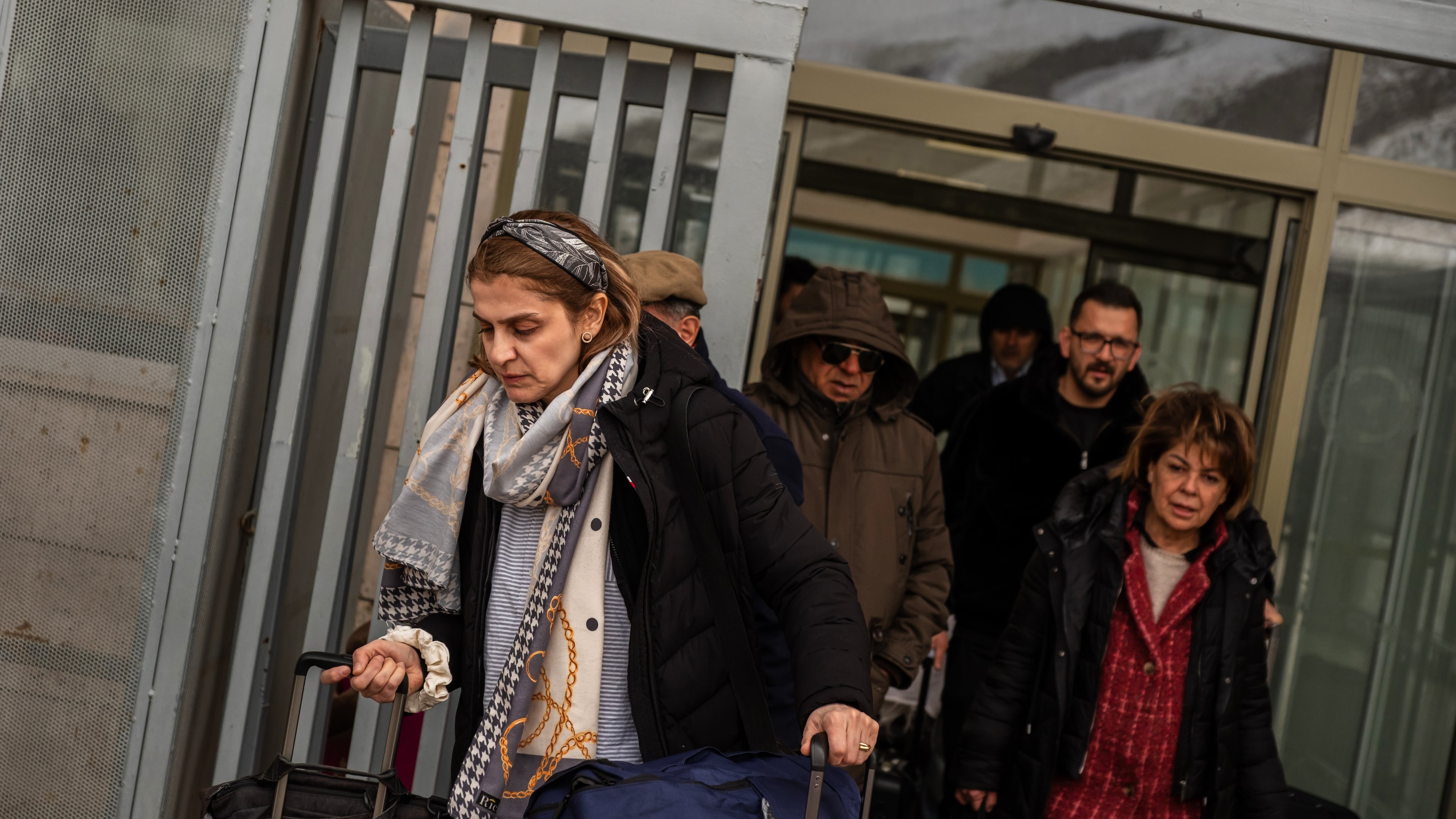 People, mostly Iranians who crossed from Iran at the Kapikoy border crossing, pull luggage in Turkey's eastern Van province, Friday, March 6, 2026. (AP Photo/Murat Kocabas)