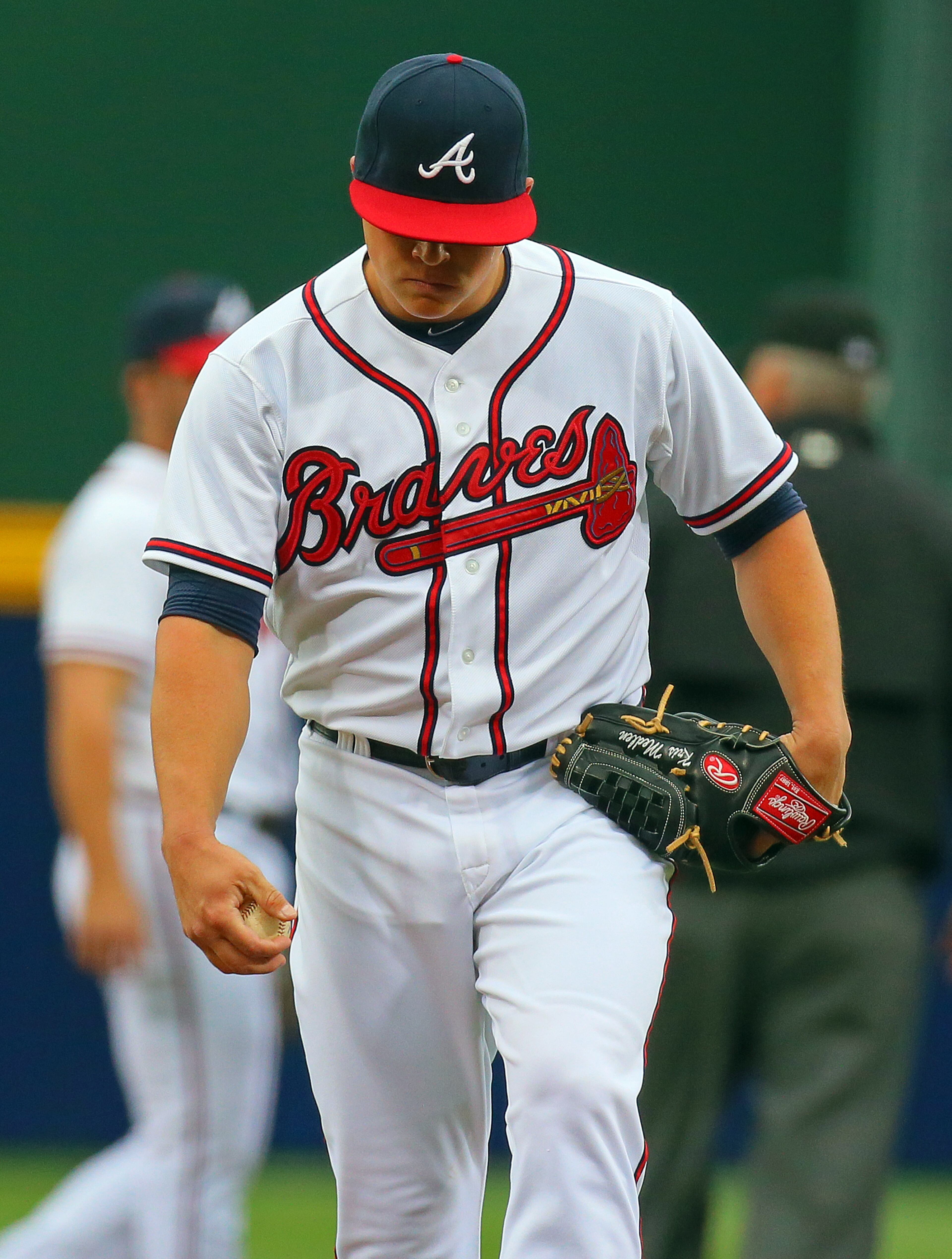 Braves pitcher Kris Medlen reacts to giving up a run to the Nationals during the first inning.
