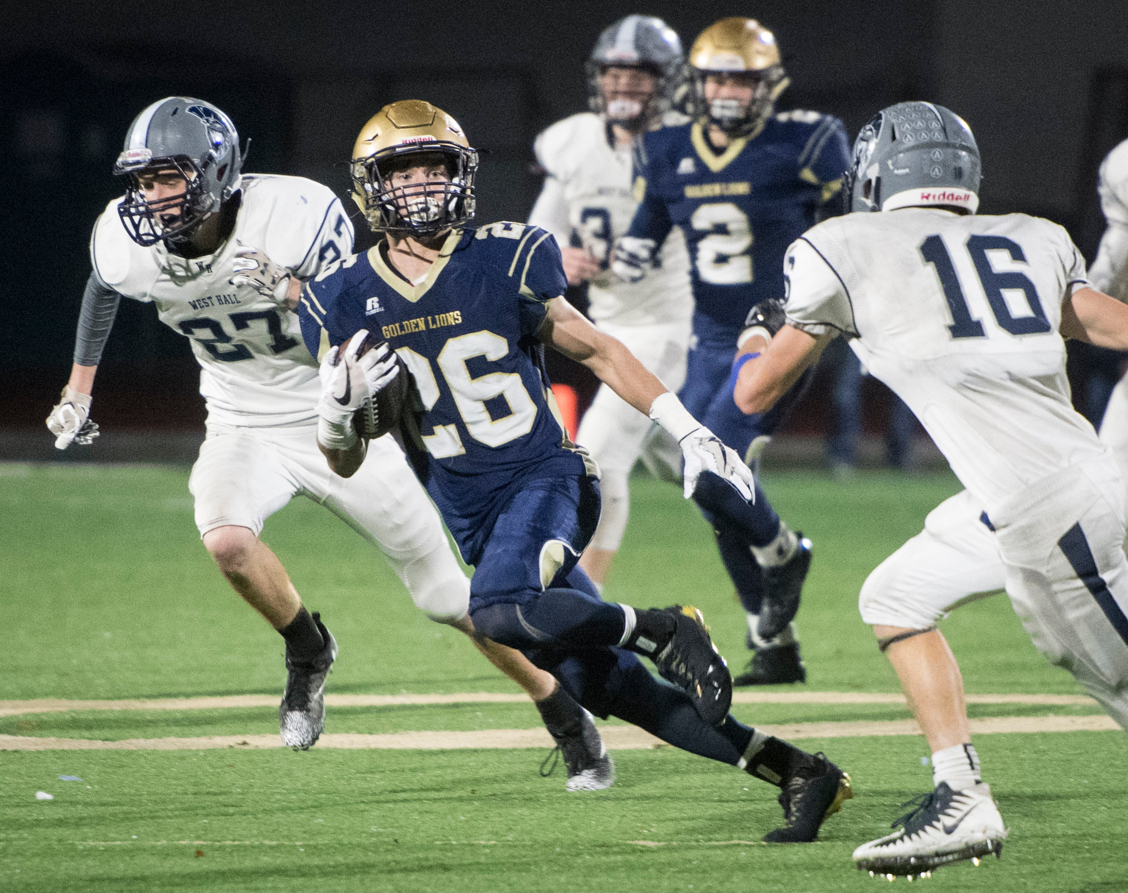 St. Pius X RB Samuel Schwaner (26) runs as West Hall safety Cameron Shirley (16) and LB John Stoecker (27) defend during the first round of a AAAA state playoff football game, Friday, Nov. 10, 2017, in Chamblee. (John Amis)