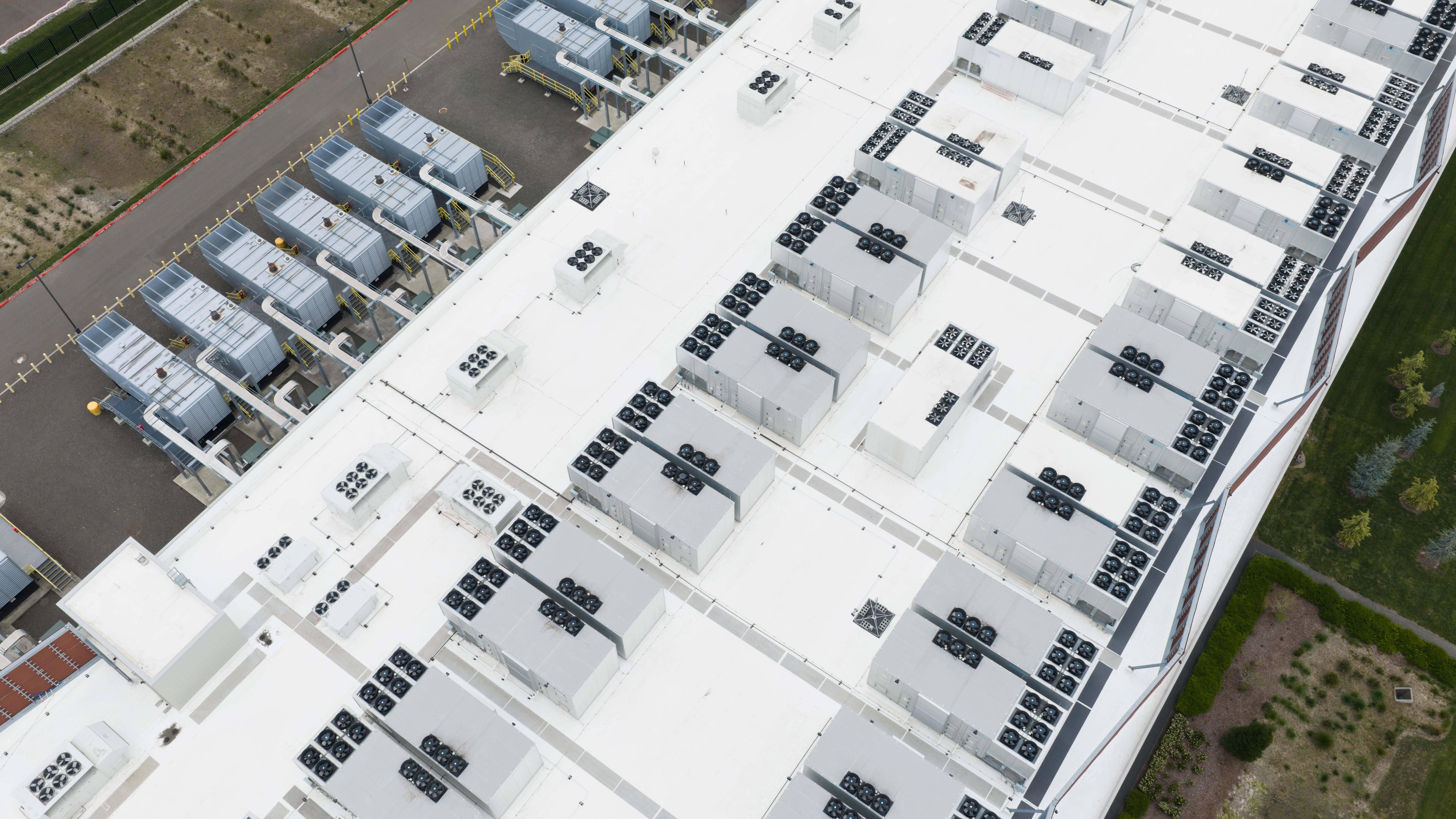 FILE - Fans, part of a cooling system, are visible on the roof of a data center April 27, 2026, in Hillsboro, Ore. (AP Photo/Jenny Kane, File)