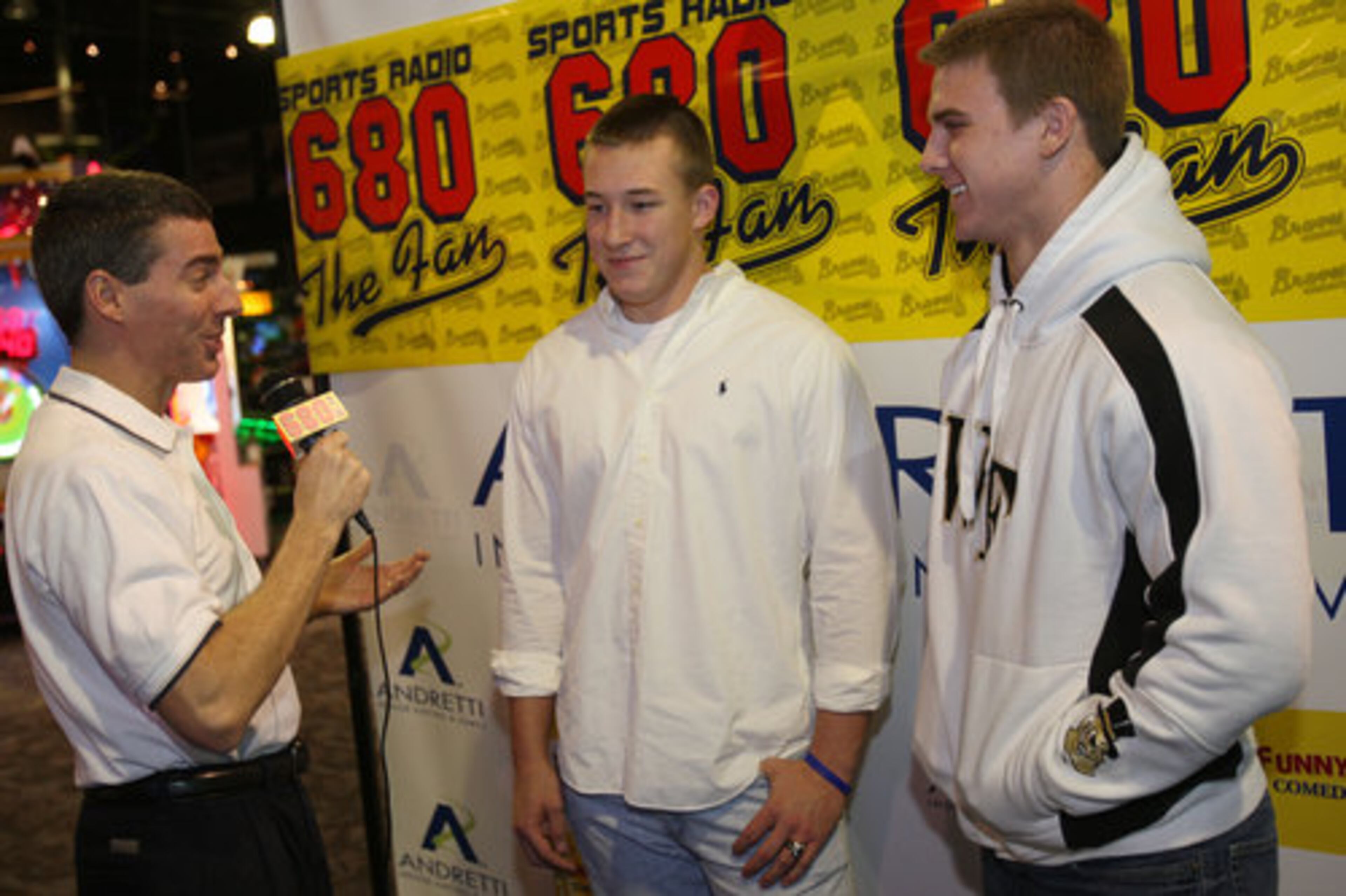 Doug Konkel of Sports Radio 680 speaks with West Forsyth High students Nathan Teter, middle, and Ben Emert during National Signing Day at Andretti Indoor Karting & Games in Roswell Wednesday, February 3, 2010. Teter plans to attend University of West Georgia and Emert with Wake Forest.