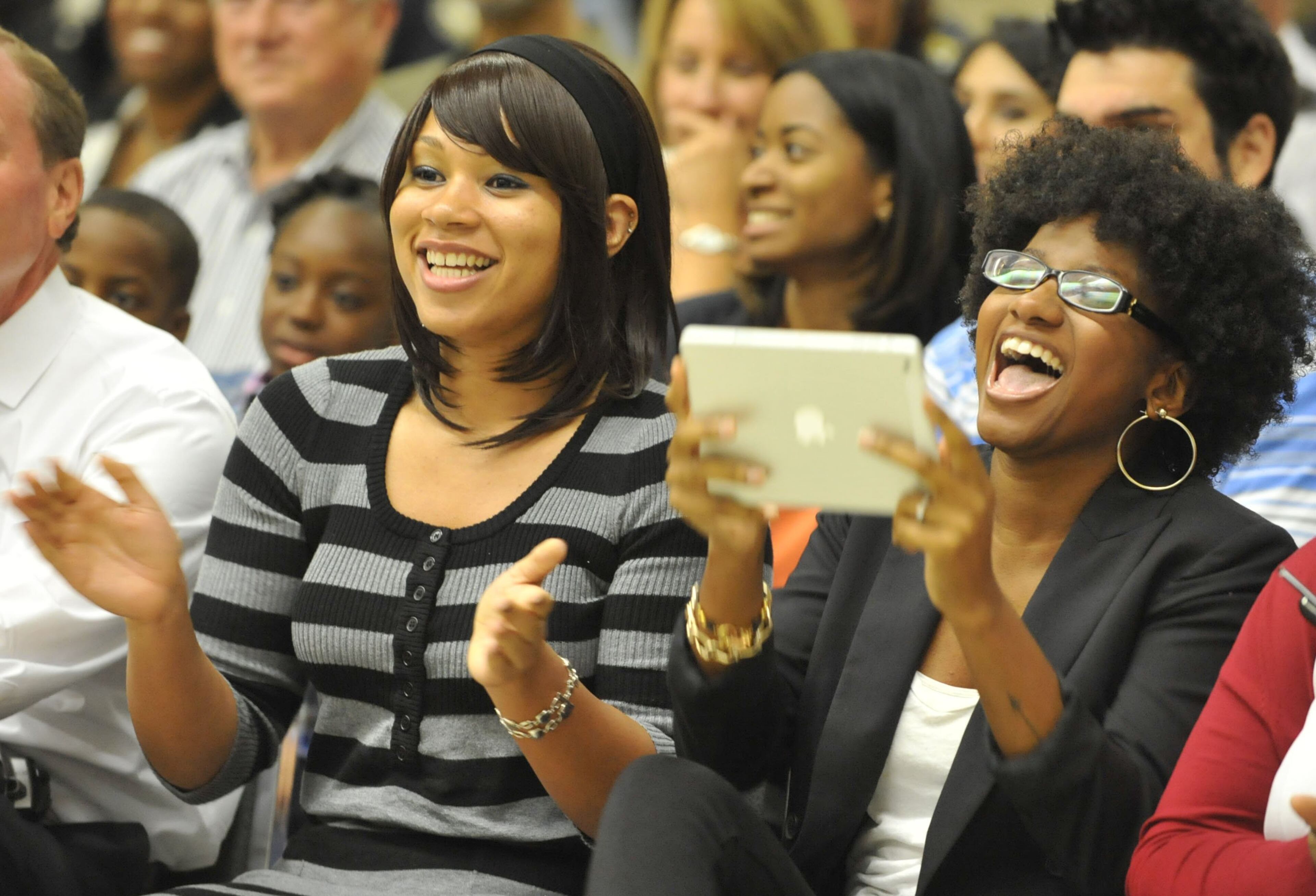 Erica Tyer (left), sister of new officer Joseph Tyer and his financee, Candice Artis, celebrate during the ceremony. The Atlanta Police Department swore in officers with Class #232 at the Atlanta Police Training Academy on Thursday, October 17, 2013. Twenty-six officers participated in the ceremony that concludes 22 weeks of rigorous training at the Atlanta Police Academy. Training consisted of classroom courses in constitutional law, local and state laws, Atlanta Police Department policy and procedure, hands-on defensive tactics, arrest techniques and daily physical fitness. Next, these officers will experience 12 weeks of field training with veteran officers. KENT D. JOHNSON / KDJOHNSON@AJC.COM
