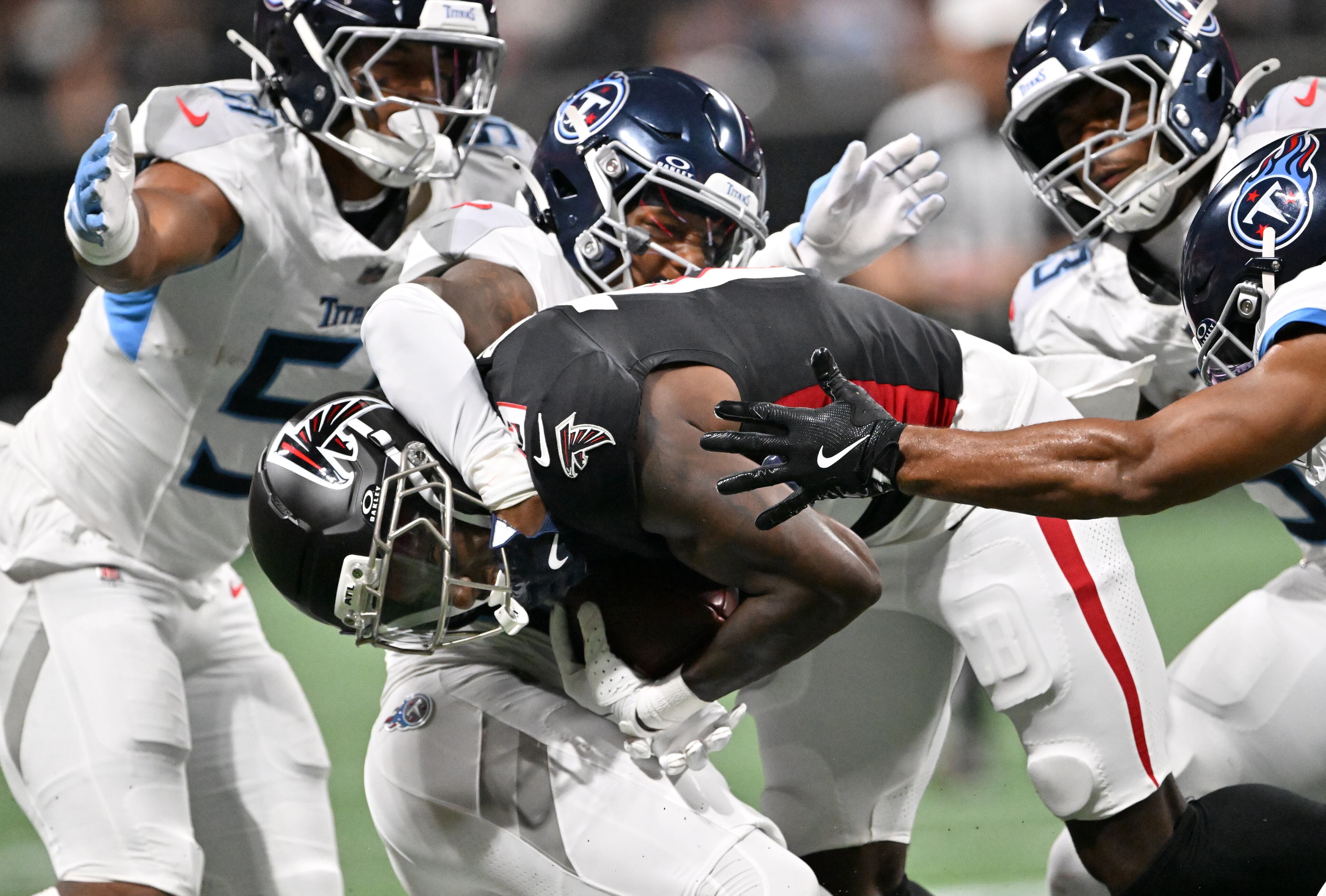 Atlanta Falcons wide receiver Chris Blair gets tackled by Tennessee Titans cornerback Marcus Harris during the first half of an NFL preseason game at Mercedes-Benz Stadium, Friday, August 15, 2025, in Atlanta. (Hyosub Shin/AJC)