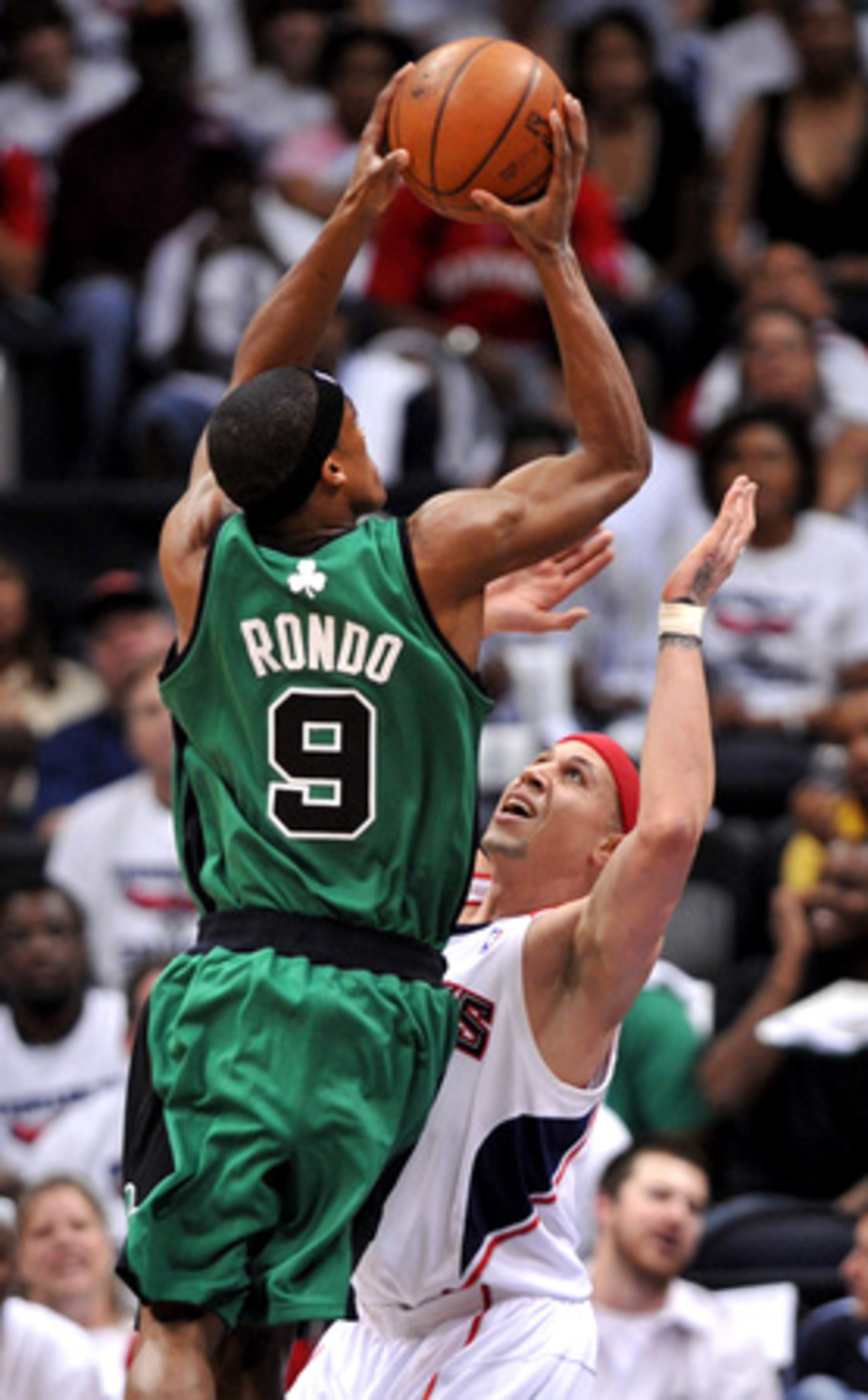 Celtics guard Rajon Rondo gets the best of the Hawks' Mike Bibby.