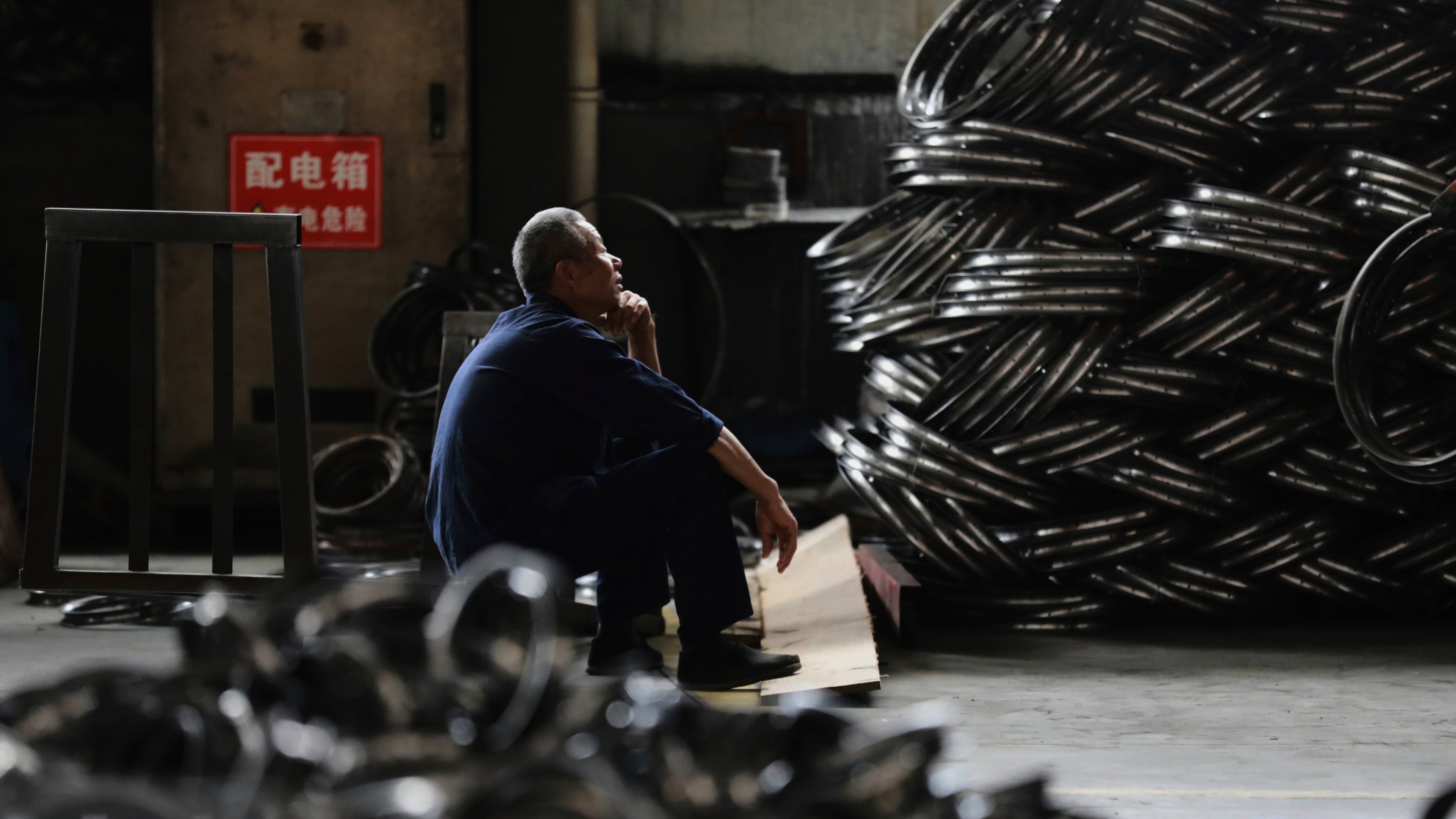 FILE - A worker takes a rest at a factory making steel bike rims for export to U.S., in Hangzhou in east China's Zhejiang province, on Friday, April 11, 2025. (Chinatopix Via AP, File)