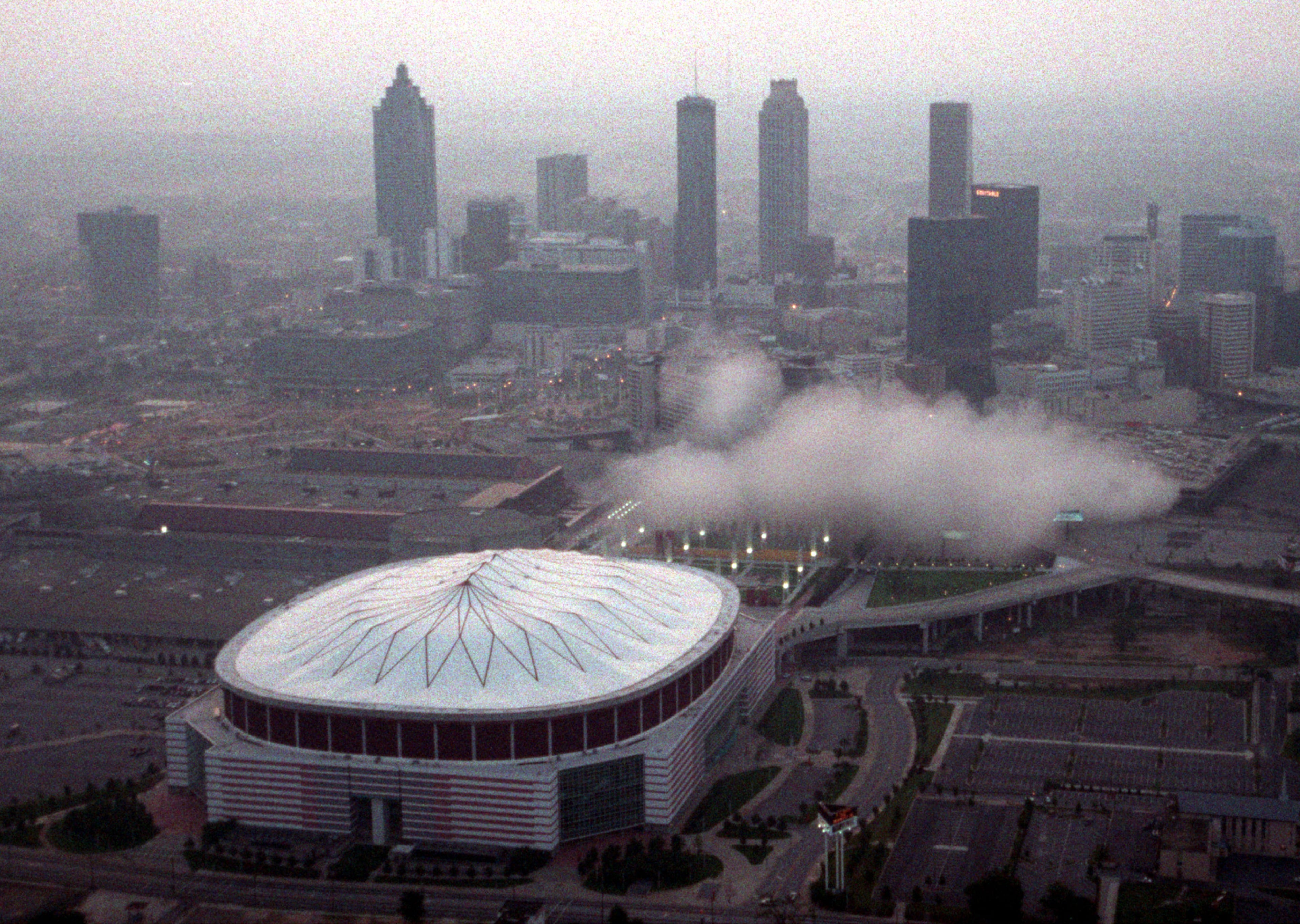 970726 - Atlanta, Georgia - This aerial photo shows a cloud of smoke and dust from the implosion of the Omni drifting away just after the implosion Saturday morning, July 26, 1997. (AJC Staff Photo/Mark Adams)