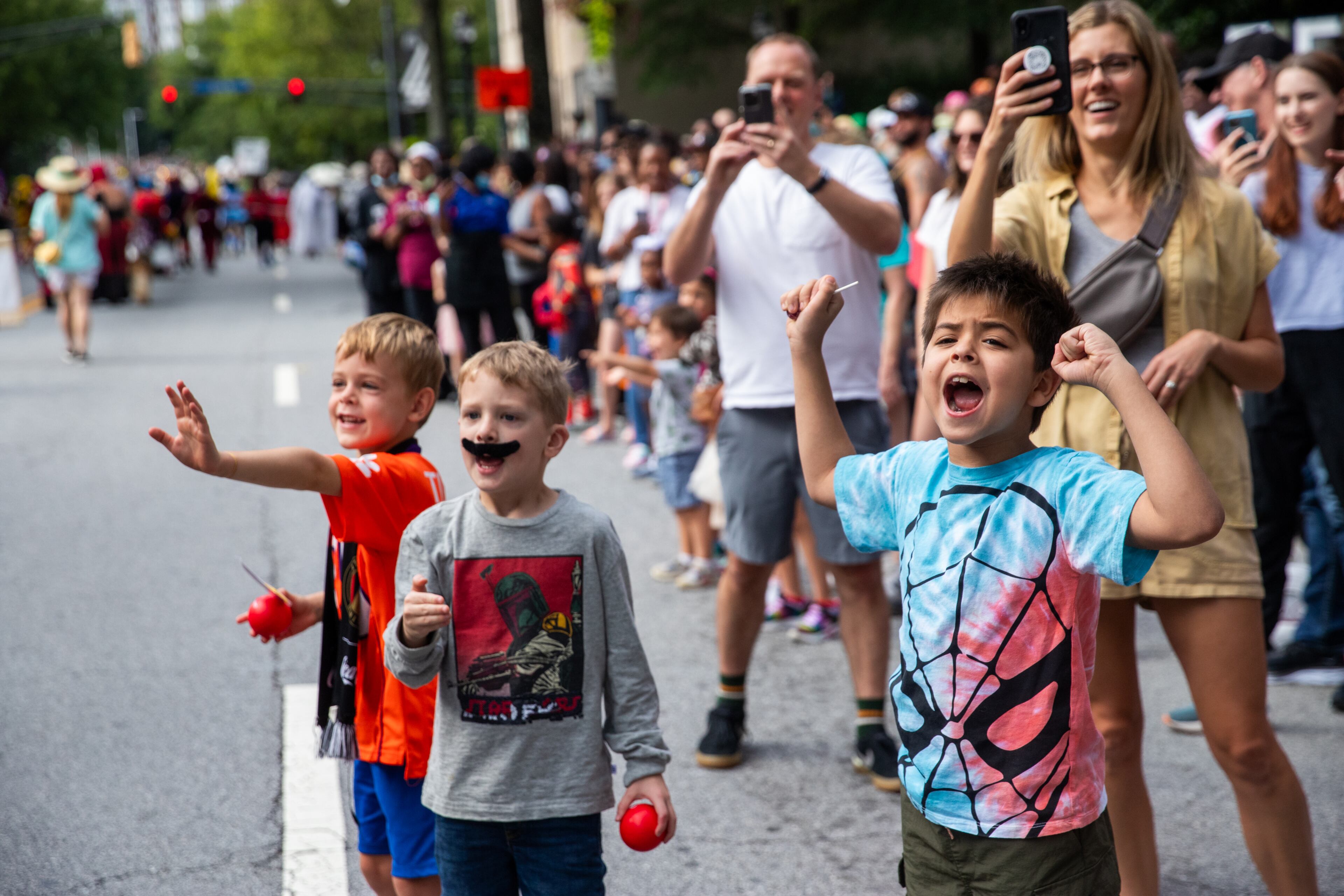 Leo Lopez, 7, right, gets excited during the annual DragonCon Parade takes place on Peachtree Street on Saturday, Sept 2, 2023. (Jenni Girtman for The Atlanta Journal-Constitution)