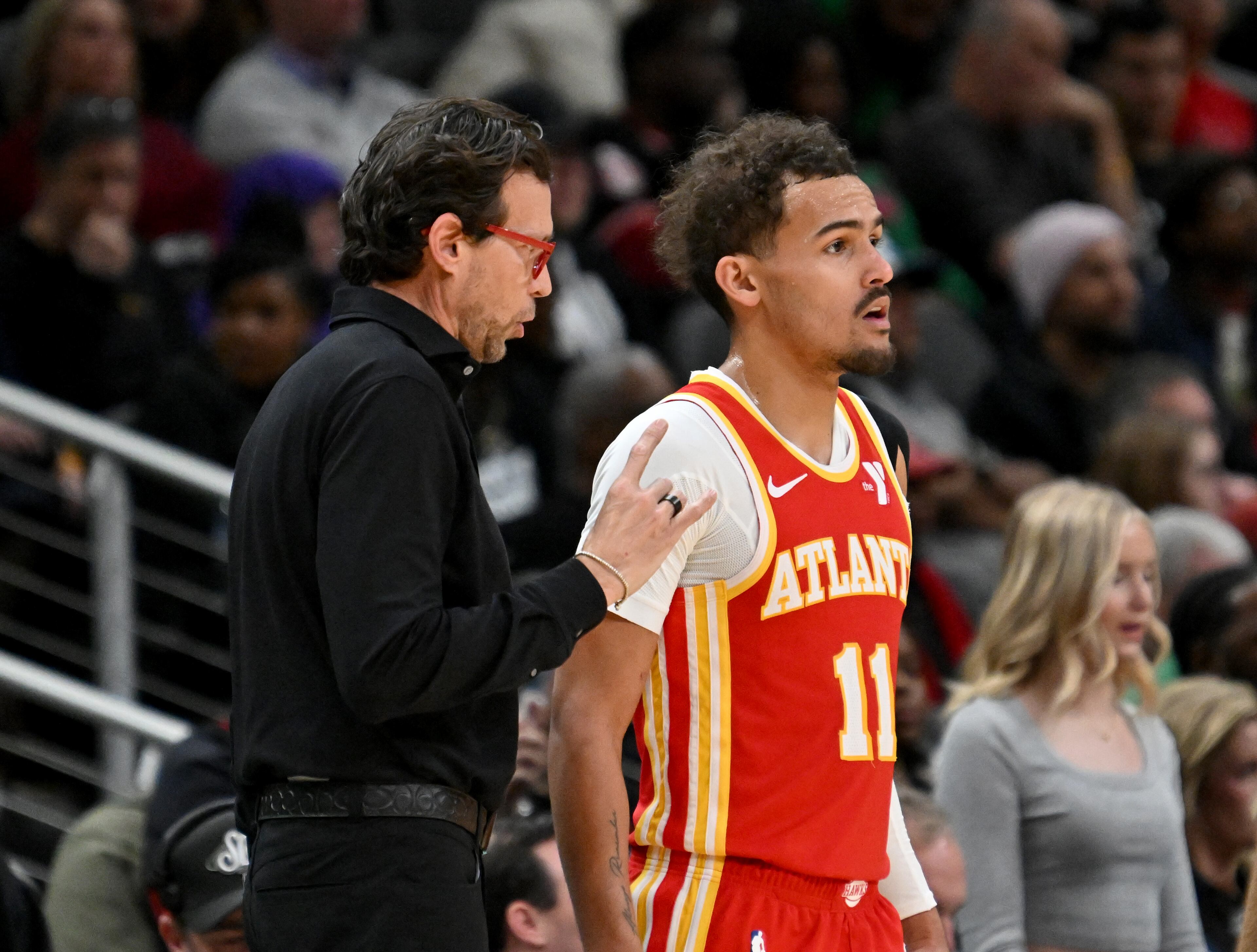 Atlanta Hawks head coach Quin Snyder confers with Atlanta Hawks guard Trae Young (11) during the second half in an NBA basketball game at State Farm Arena, Wednesday, December 3, 2024, in Atlanta. Atlanta Hawks won 141-138 over Oklahoma City Thunder. (Hyosub Shin / Hyosub.Shin@ajc.com)