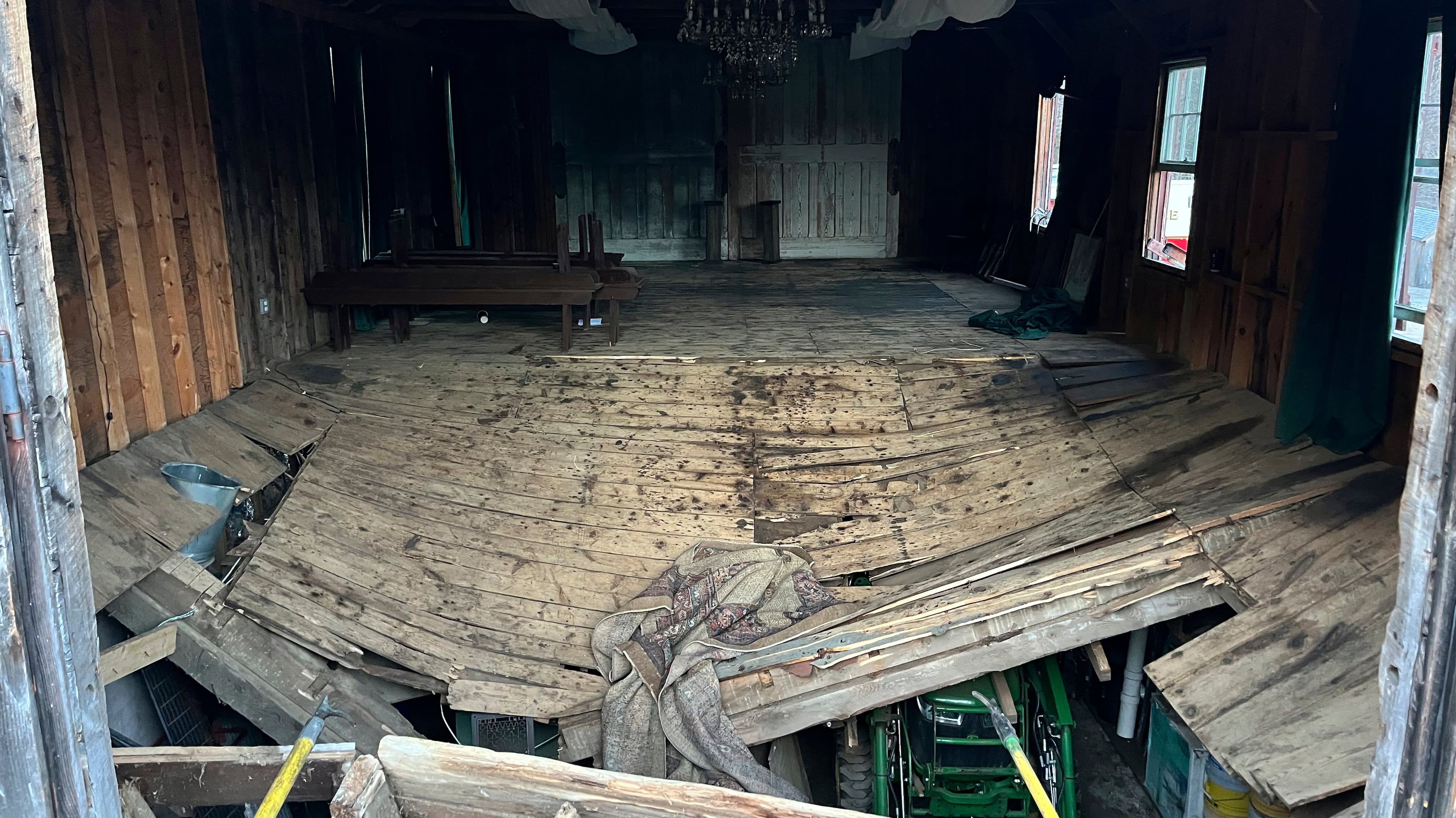 A photo provided by the New Hampshire State Fire Marshal's Office shows the buckled floor that collapsed Saturday, sending nearly 70 wedding guests into the basement of a building in Tamworth, N.H. Saturday, March 21, 2026. Six people were taken to the hospital with non-life-threatening injuries. (New Hampshire State Fire Marshal's Office via AP)